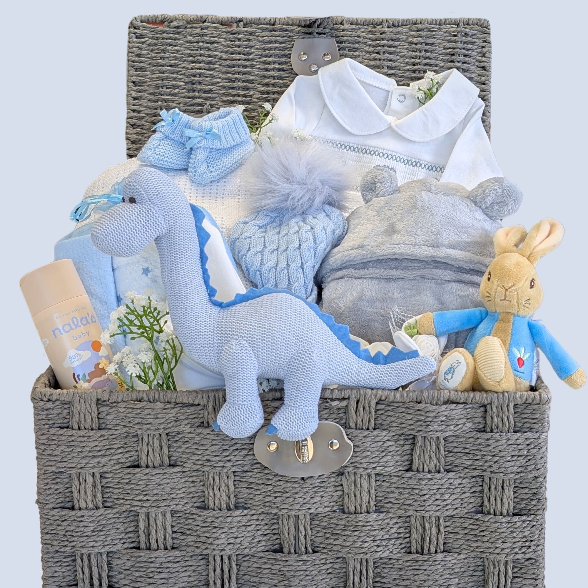 Baby boy hamper with presents packed in a basket.