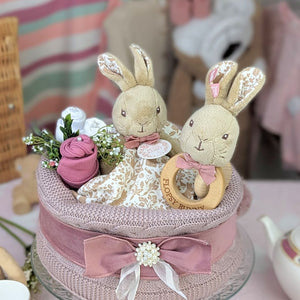 Beatrix Potter baby shower nappy cake with Flopsy Bunny sitting on a cake of nappies