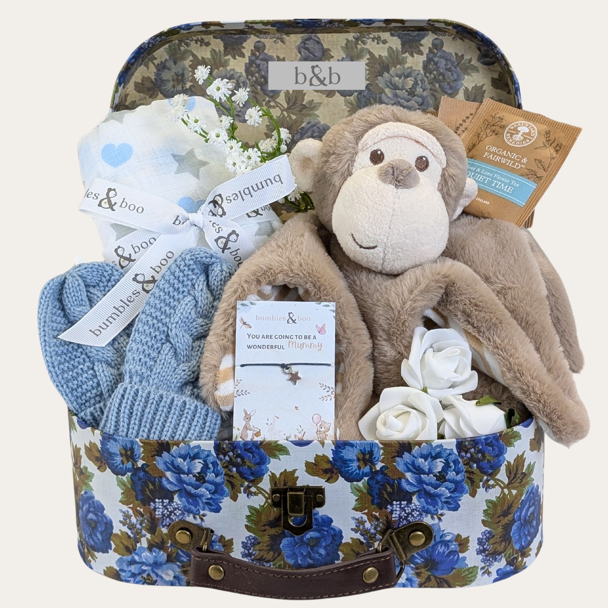 Hamper for a baby boy with gifts including monkey soft toy, muslin square, bracelet for mum and more.