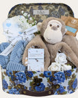 Hamper for a baby boy with gifts including monkey soft toy, muslin square, bracelet for mum and more.