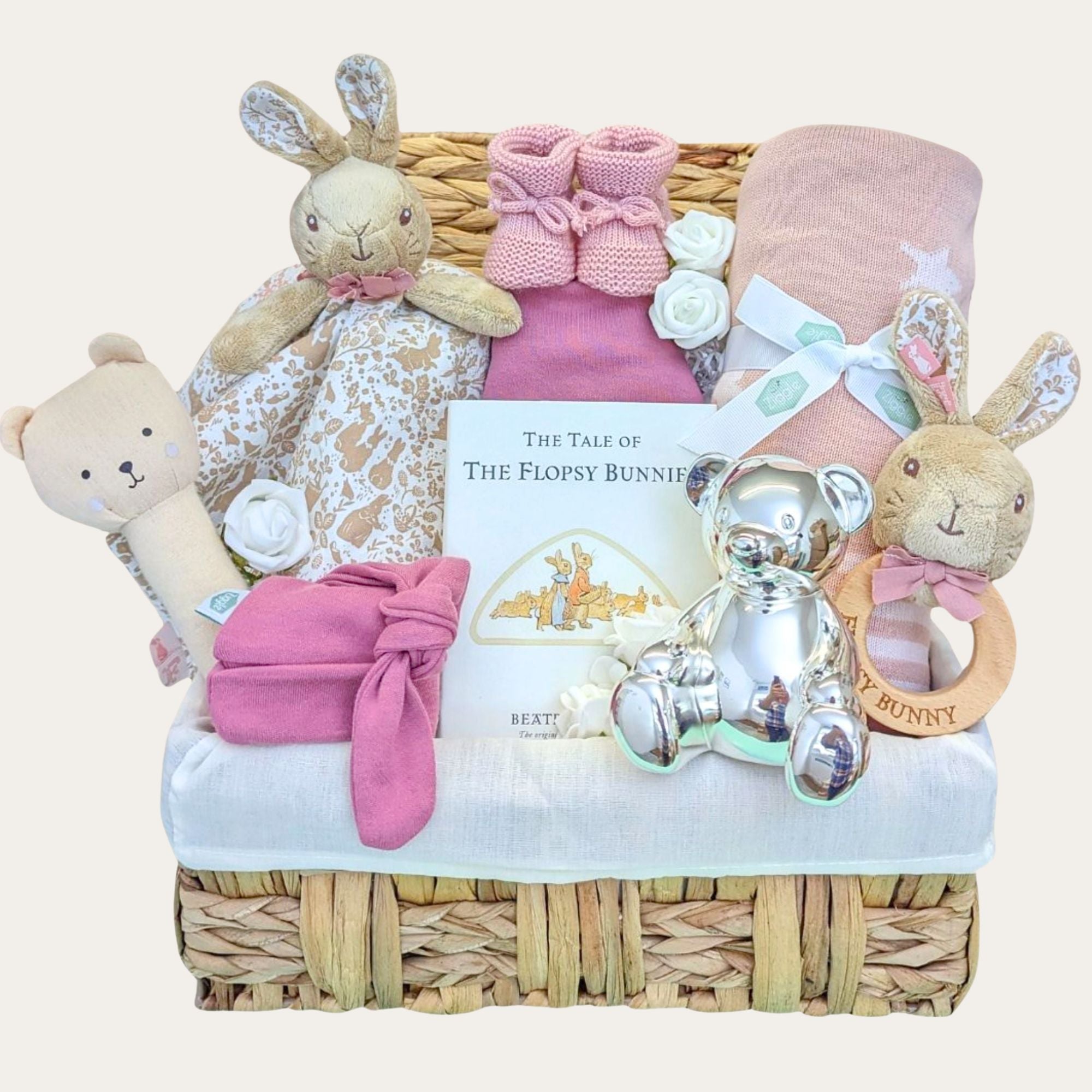 Baby girl hamper basket packed with gifts including flopsy bunny comforter and rattle. Also includes blanket & silver money box.