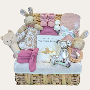 Baby girl hamper basket packed with gifts including flopsy bunny comforter and rattle. Also includes blanket & silver money box.