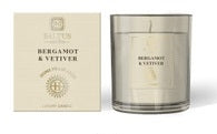 Luxury Candle bergamot and vetiver Pot in coloured glass with a lit flame