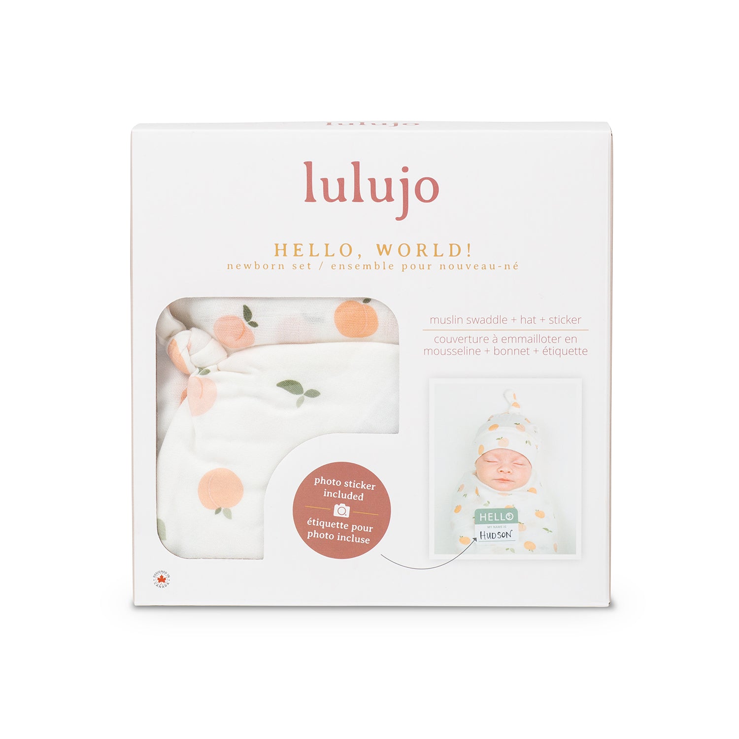 Hat and muslin swaddle gift set shown in box. Hello World with peach print. Lulujo.