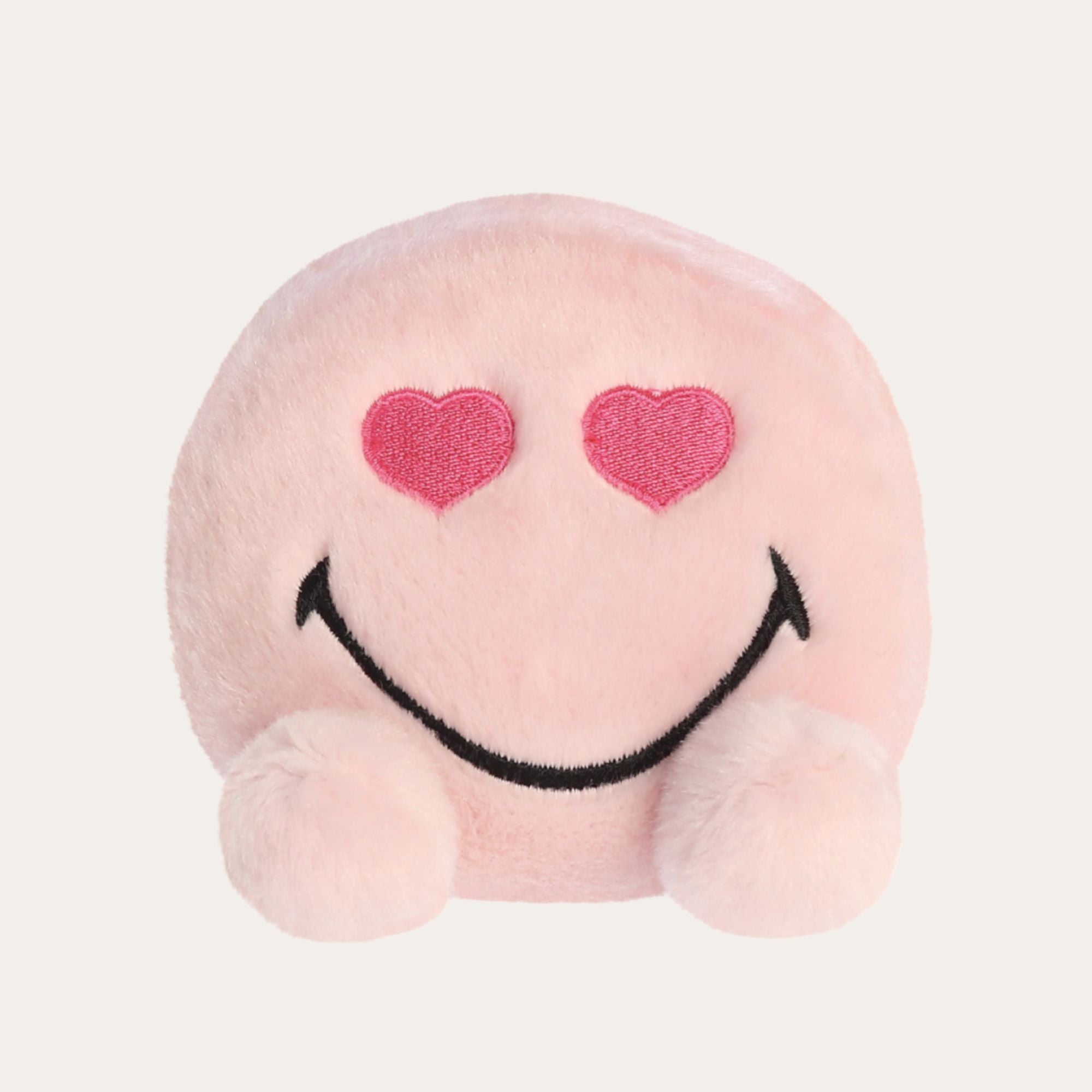 Pink soft plushy that fits in the palm of your hand with eyes shapes as pink hearts