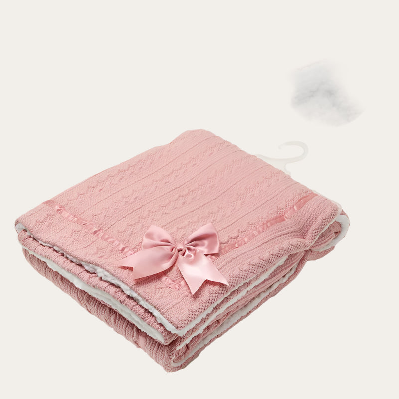 Rose Gold Sherpa Back Knit Blanket folded neatly, showing the satin bow