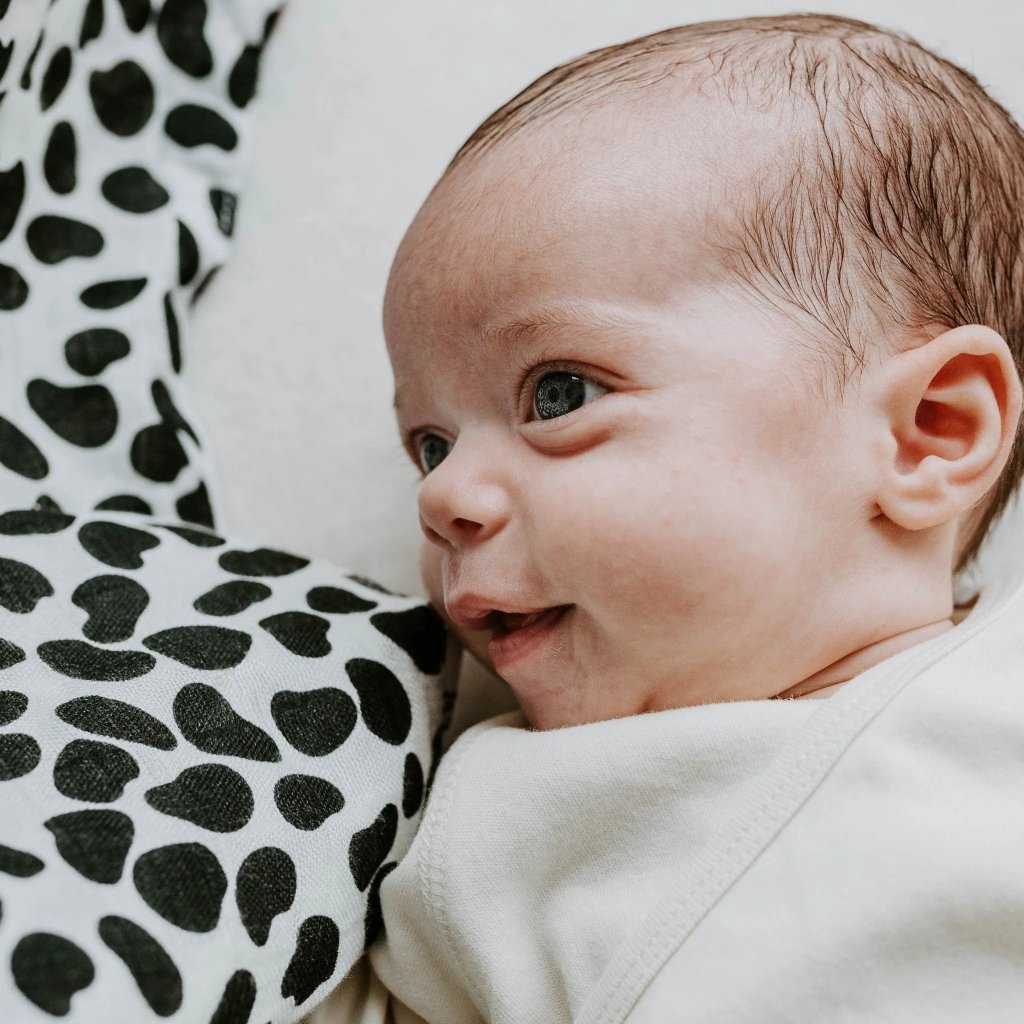 baby with black and white blanket