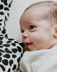 baby with black and white blanket