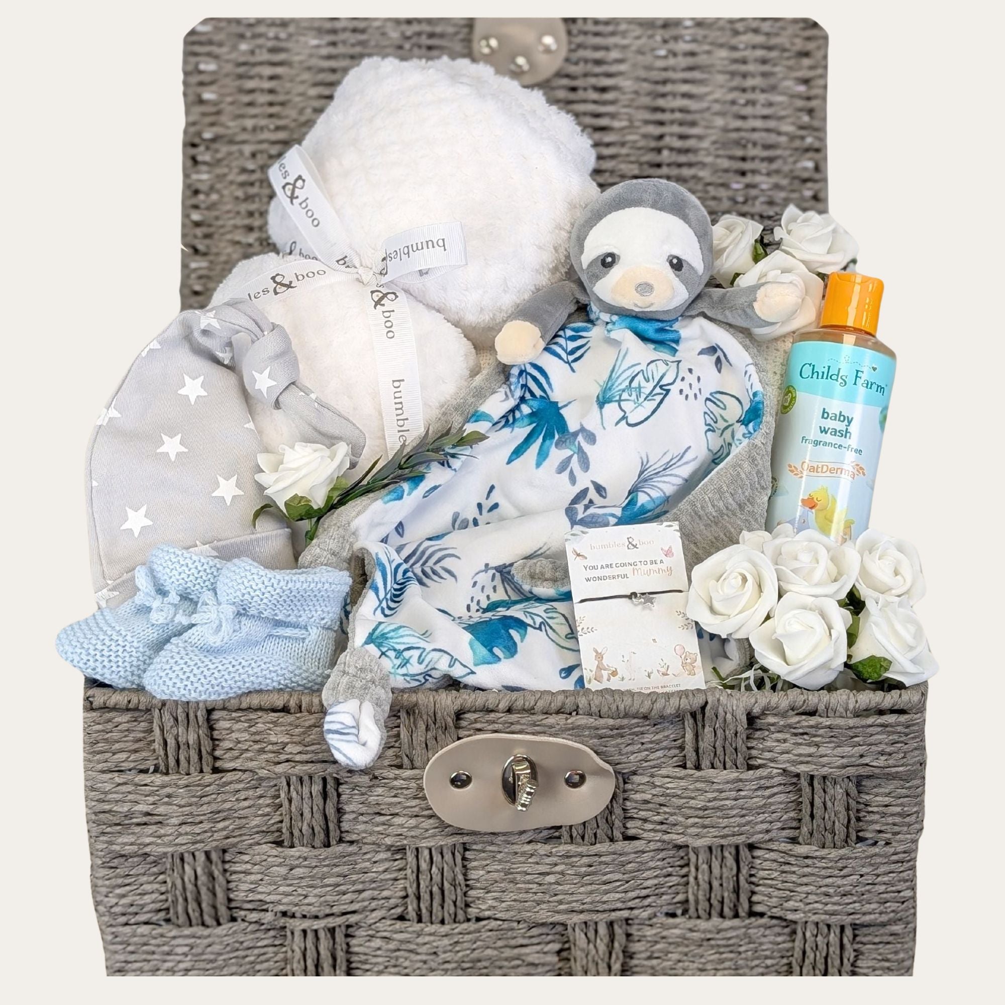 Baby boy hamper basket with gifts including sloth and baby blanket.