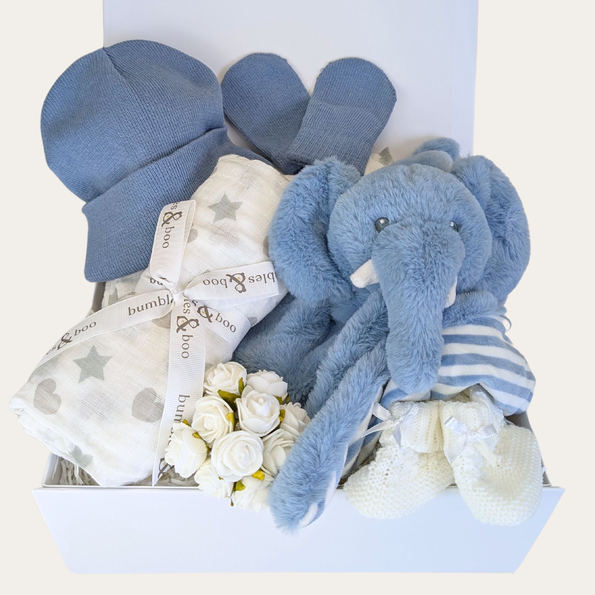 baby boy gifts box with dusky blue elephant comforter, knit baby hat and mittens plus white baby boots and muslin square.