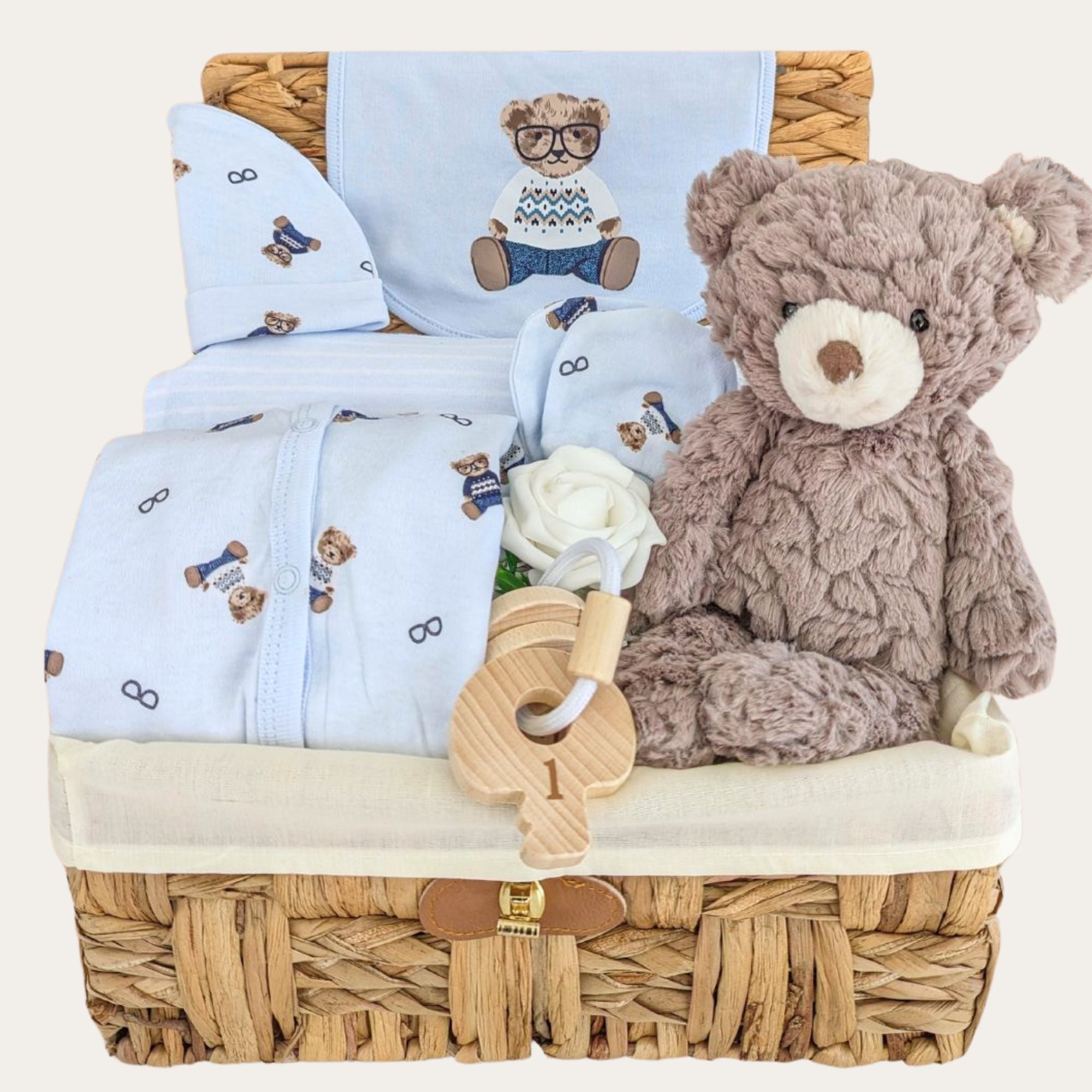 baby boy gifts hamper with a clothing set, teddy bear and teething keys.