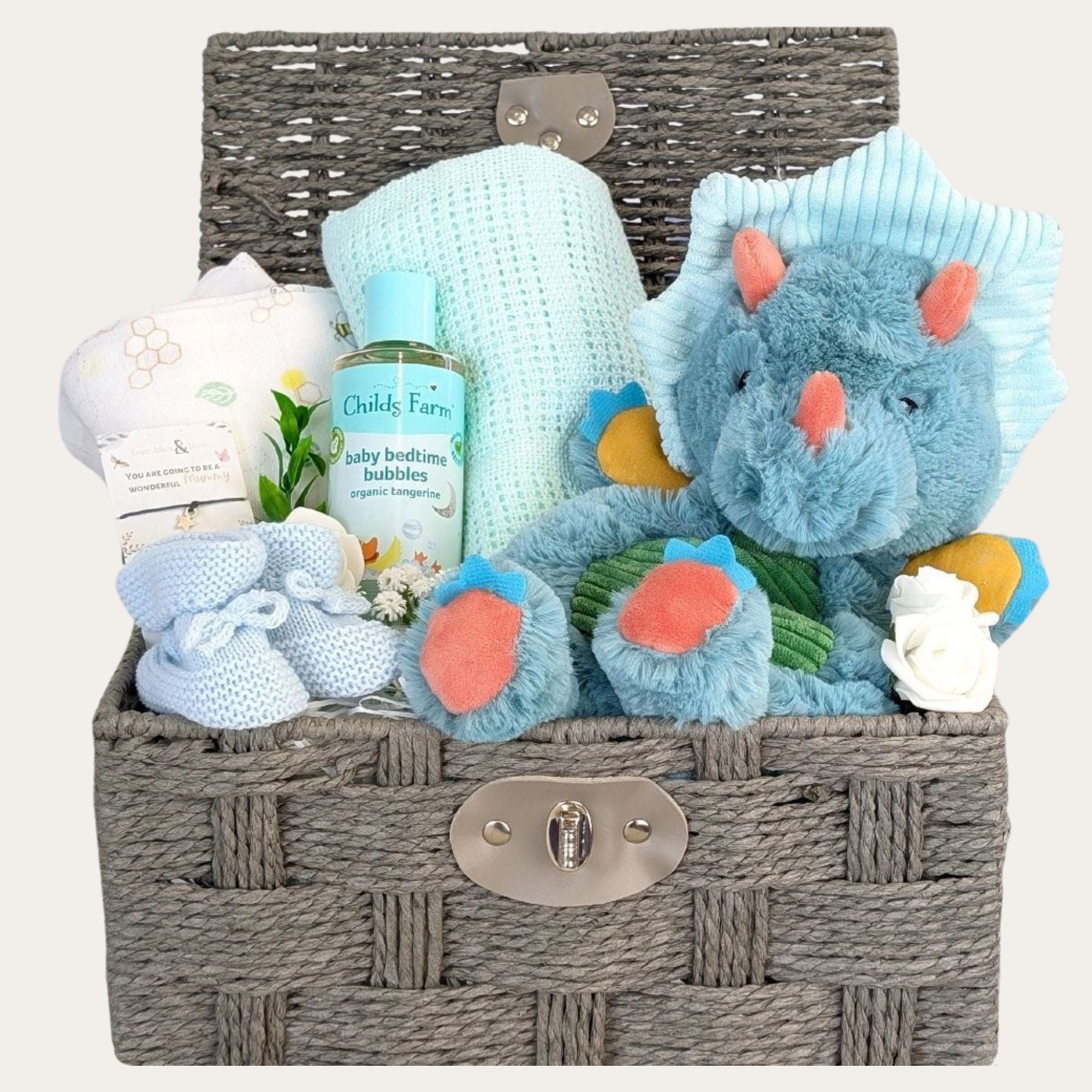 Baby boy hamper basket with gifts including dinosaur toy, blanket, muslin and baby wash.