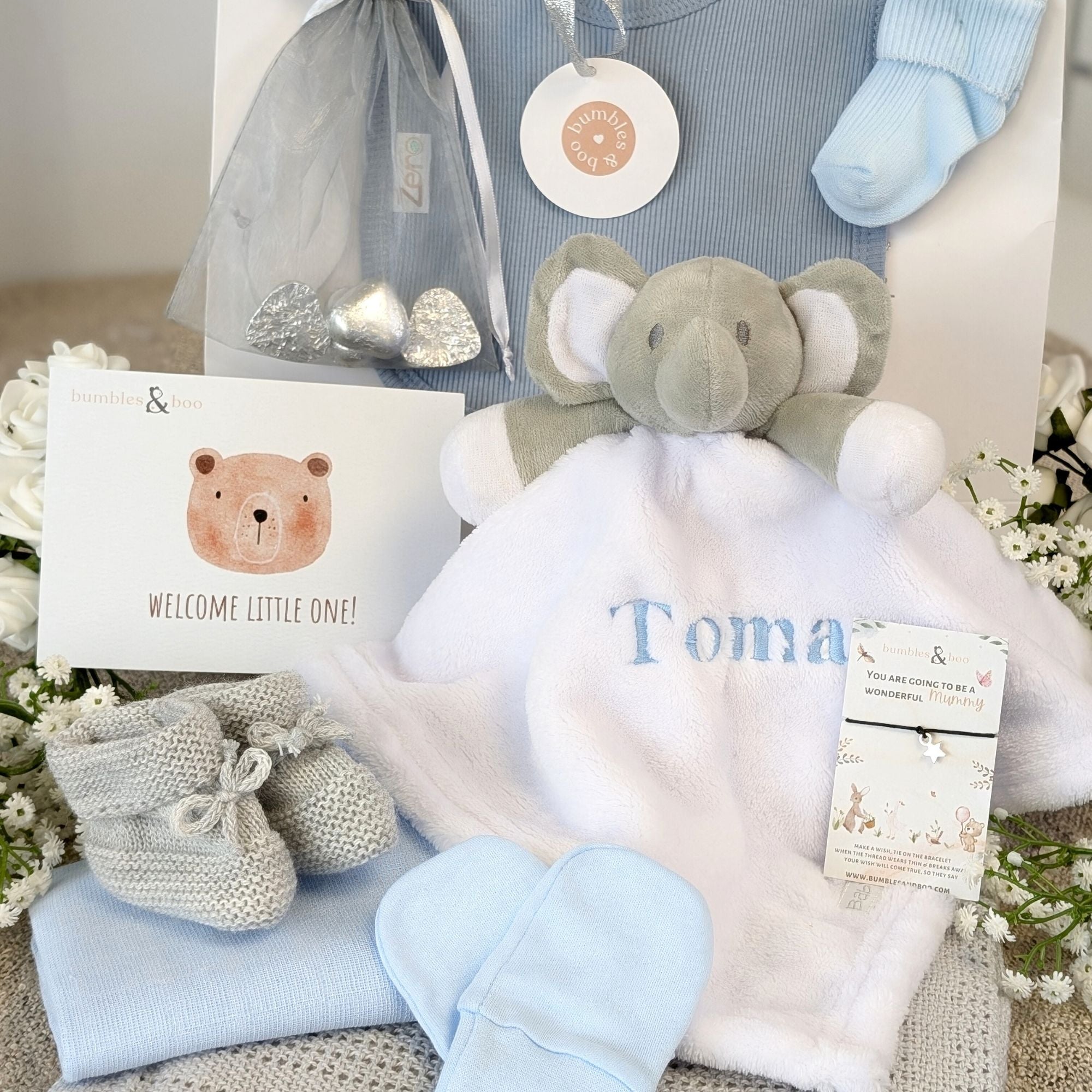 baby boy gifts hamper with bib, socks, soft toy elephant, blanket, muslin, mittens, booties and gifts for a new mum.