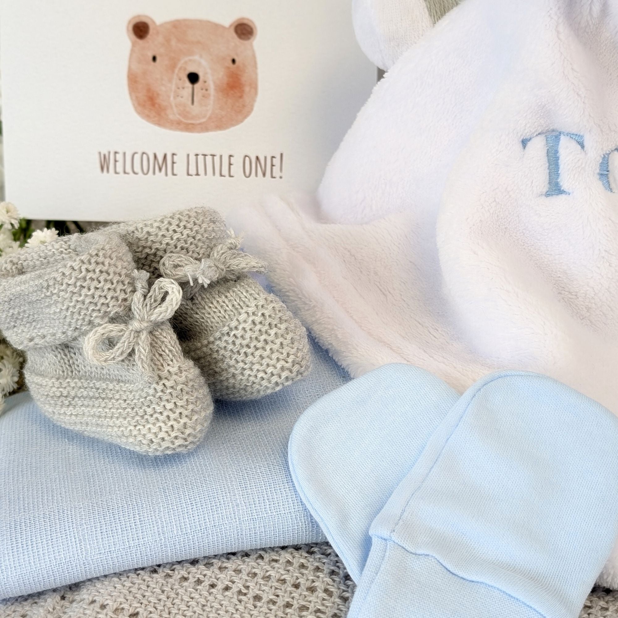 baby boy gifts hamper with bib, socks, soft toy elephant, blanket, muslin, mittens, booties and gifts for a new mum