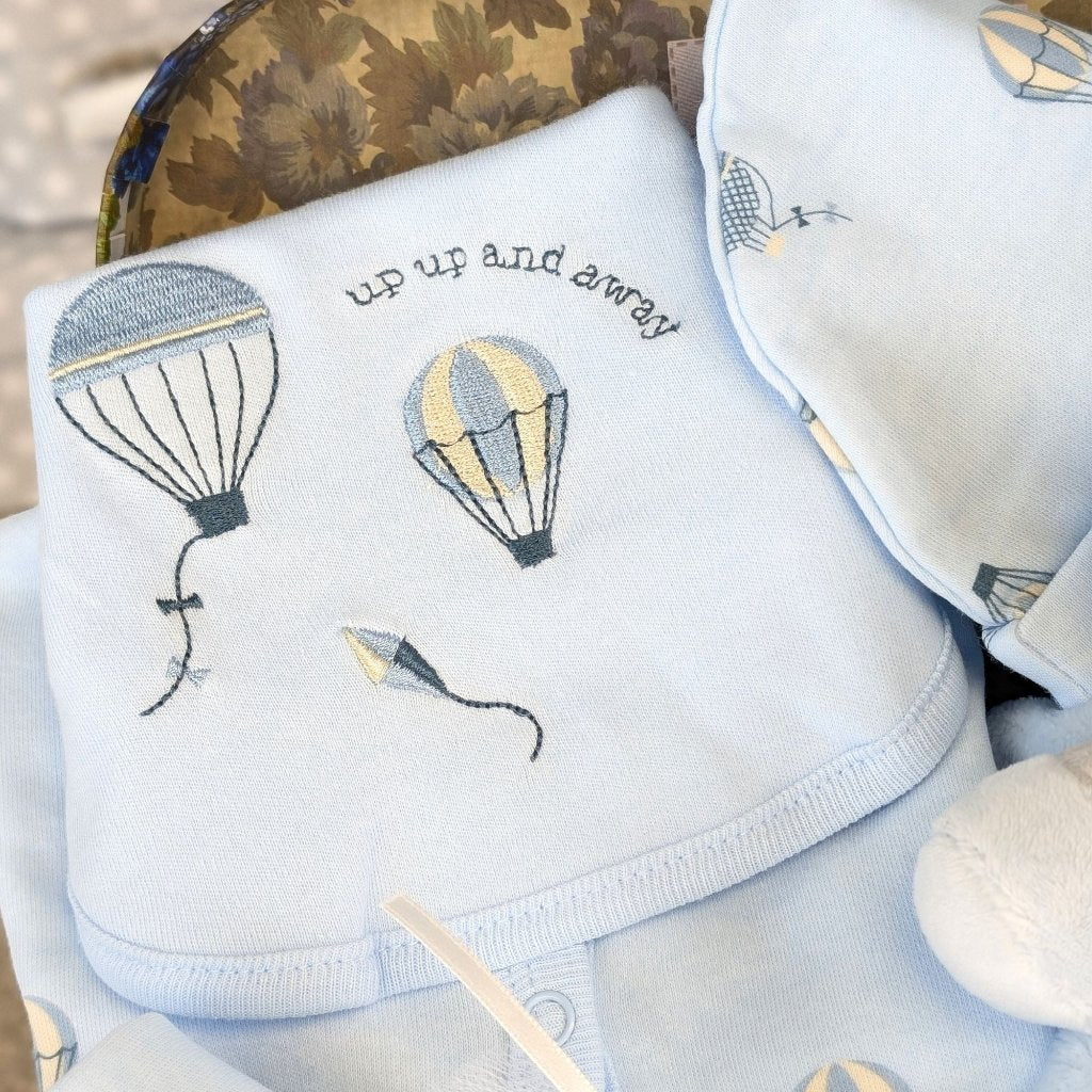 baby bib in blue with embroidery which reads up up and away