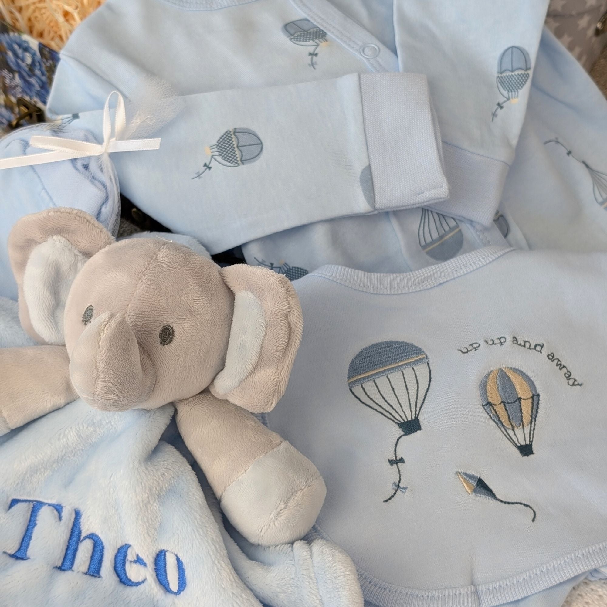 baby boy clothing set with balloons and reads up, up and away 