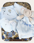 Baby boy hamper with gifts including a blue balloon clothes set and a personalised elephant comforter soft toy.