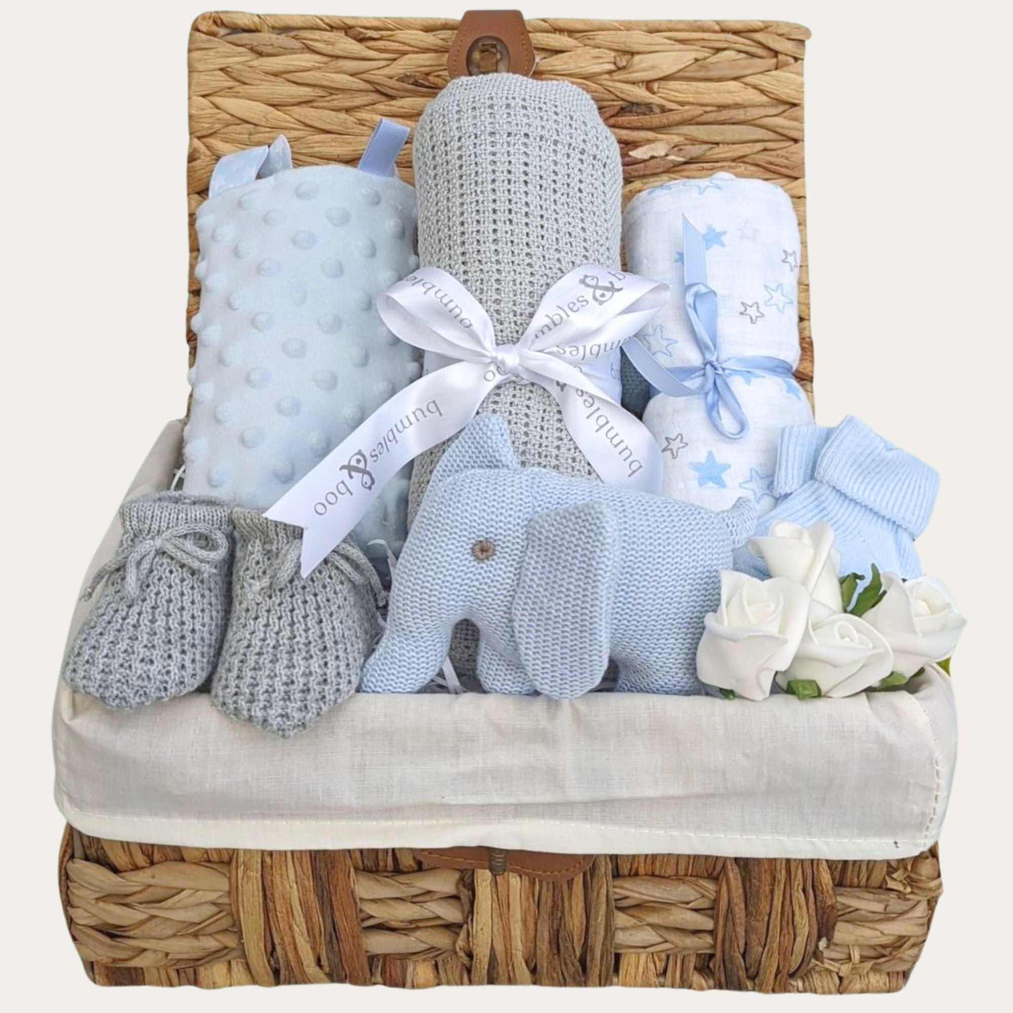 Gifts for a new baby boy in a hamper basket with grey and blue presents includes elephant rattle.