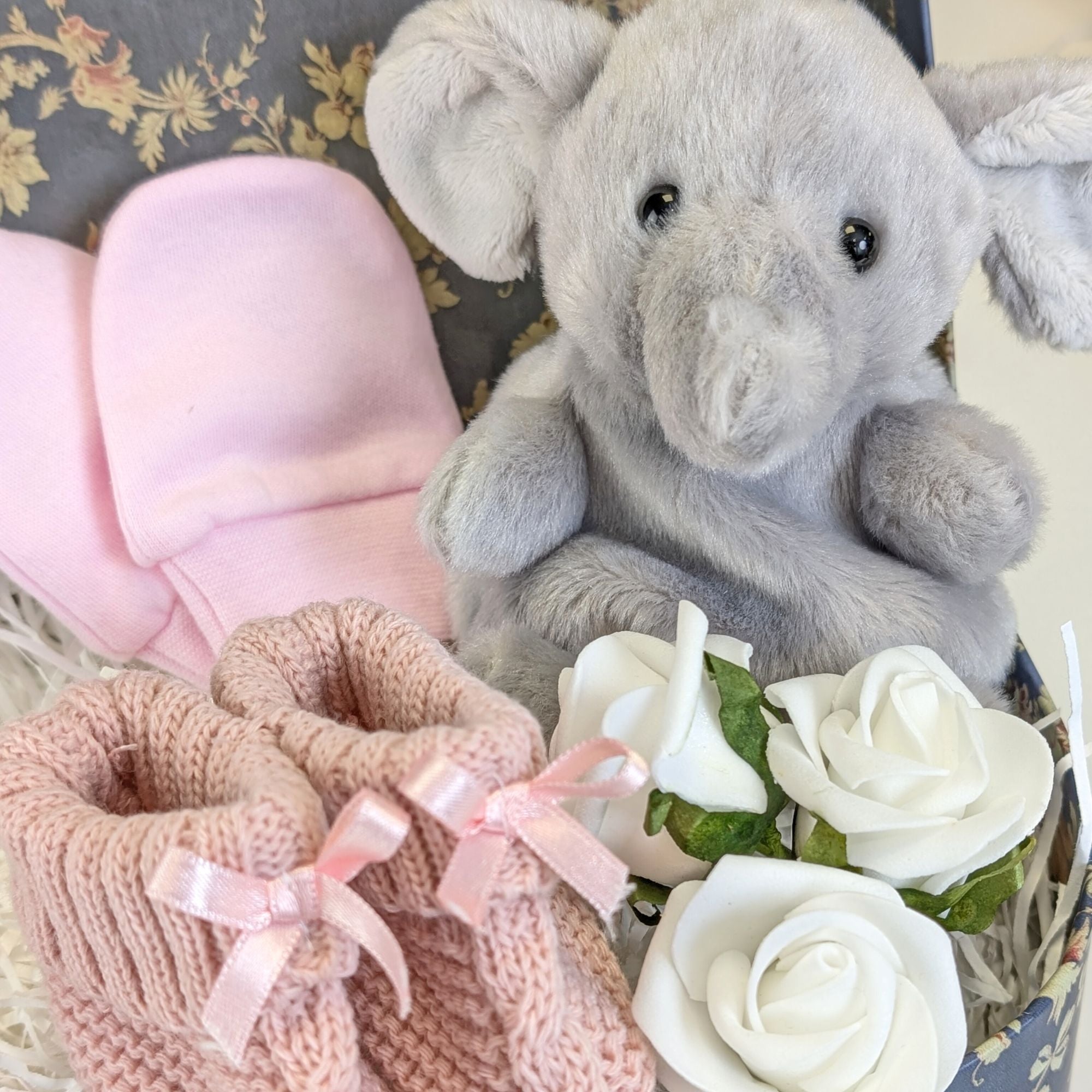 dusky pink baby booties, elephant soft toy and pink baby mittens