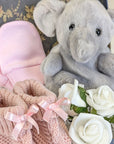 dusky pink baby booties, elephant soft toy and pink baby mittens