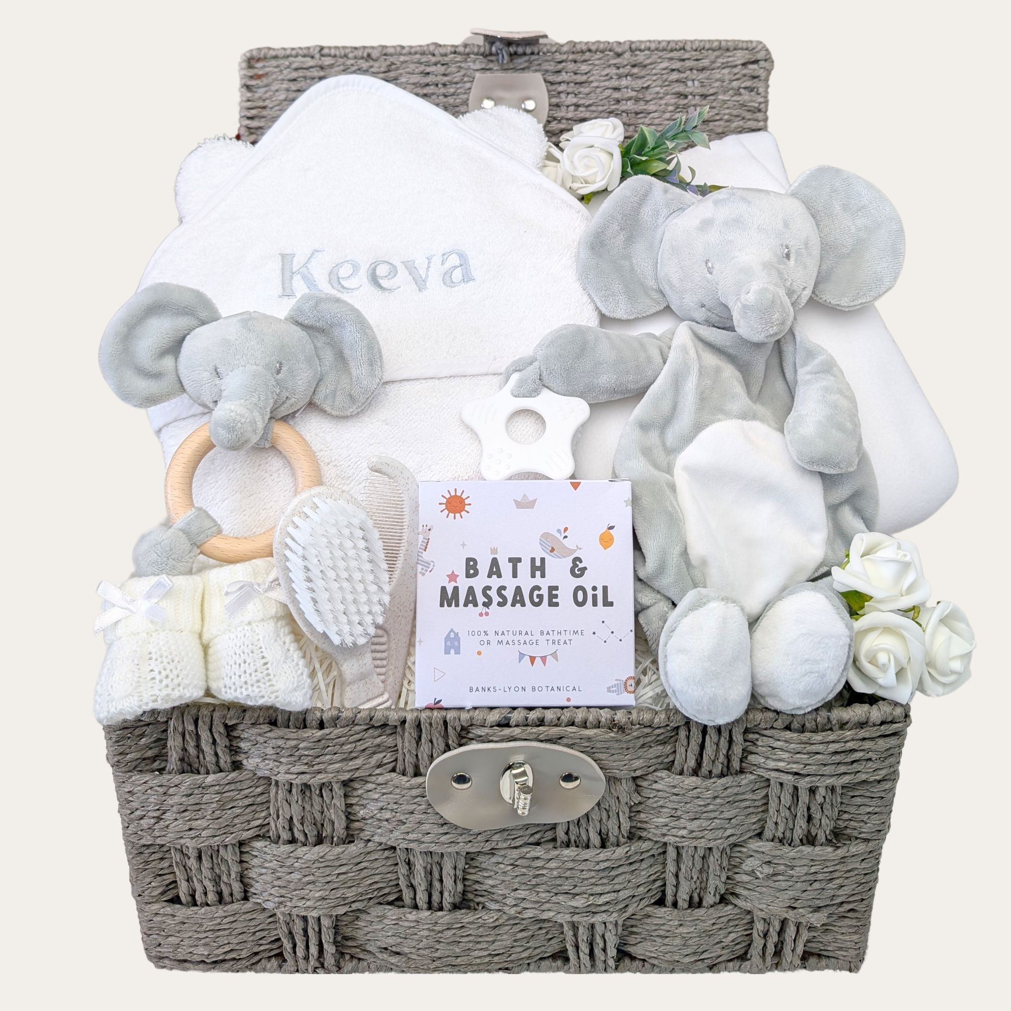 white and grey baby hamper with towel, elephant soft toy, teether, blanket and organic massage oil. Bumbles and Boo.