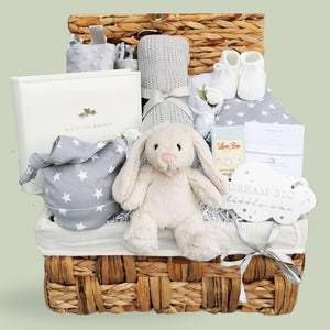 Baby Gift Hamper Basket, with gifts including white bunny toy, baby hat & bib, grey cellular balnket and photo book.