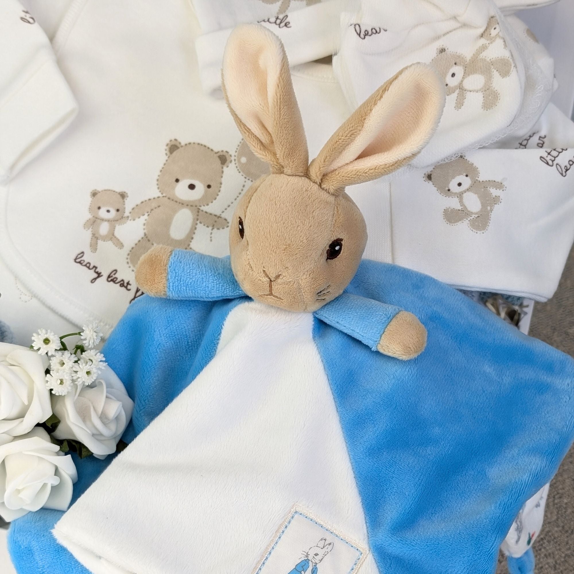 Close up of Peter Rabbit comforter in the right corner of the hamper.