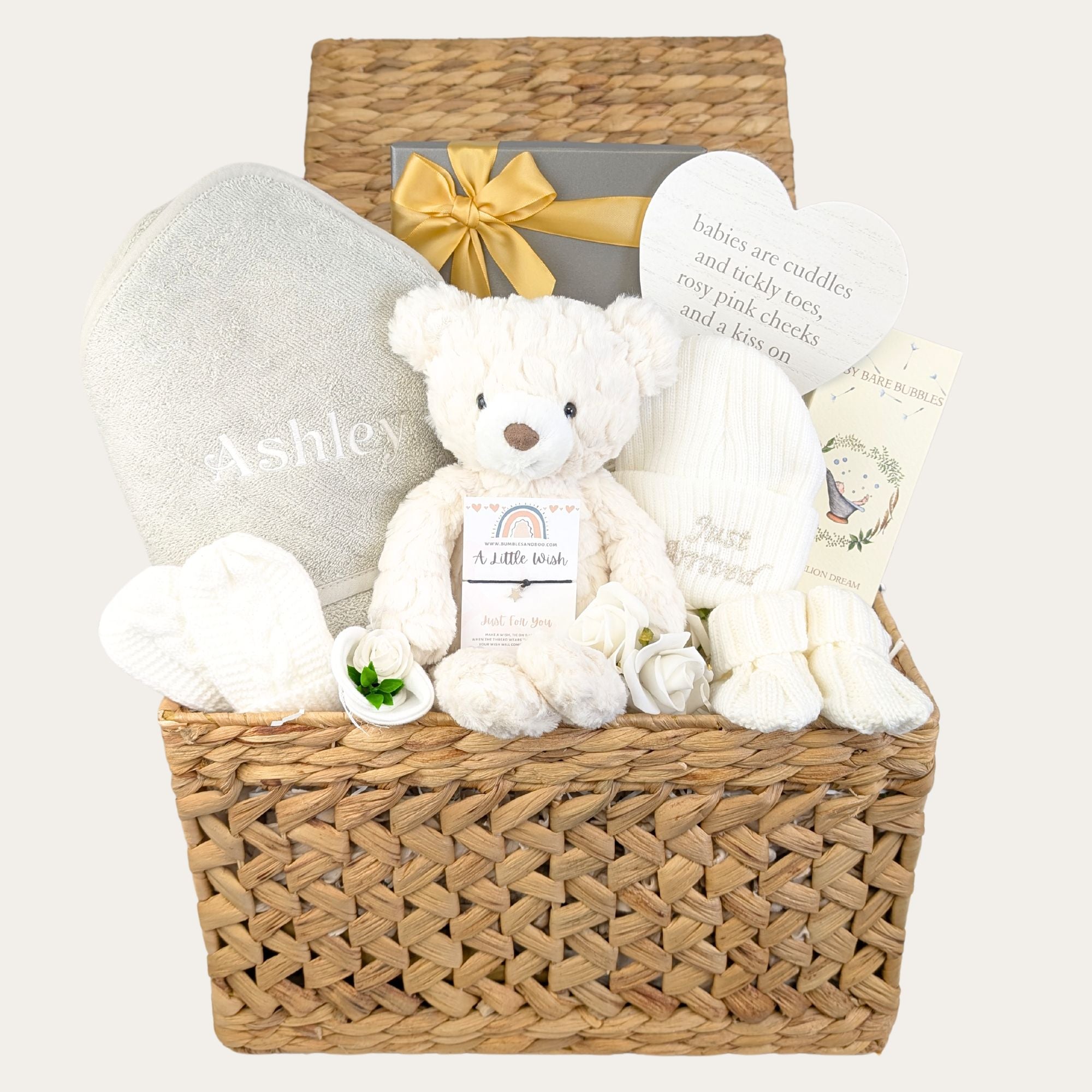 Baby gifts basket with white teddy bear. This hamper also contains a hooded bath robe and other products-designed by Bumbles and Boo.