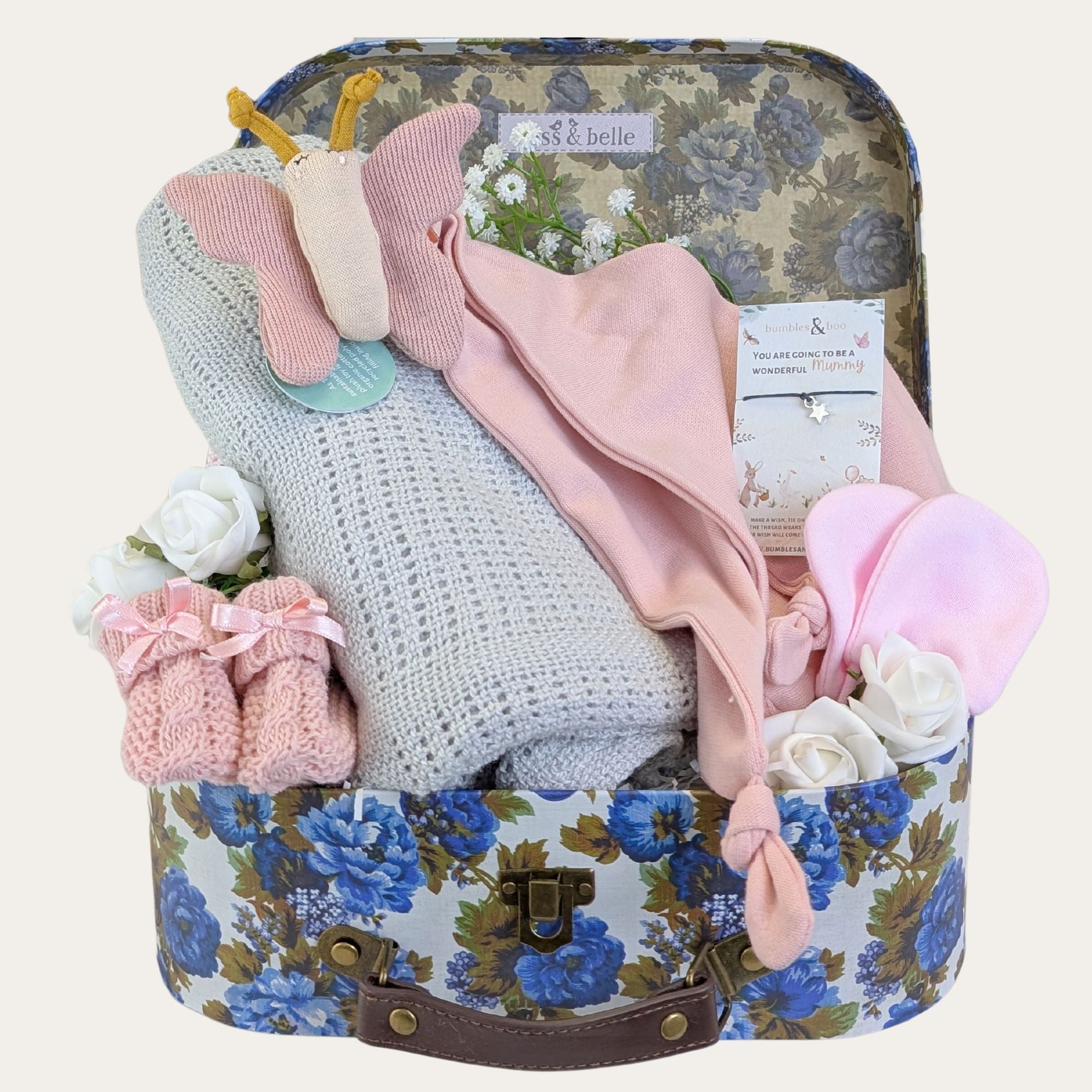 baby girl gifts hamper trunk with presents including butterfly comforter, blanket, booties and baby mittens.