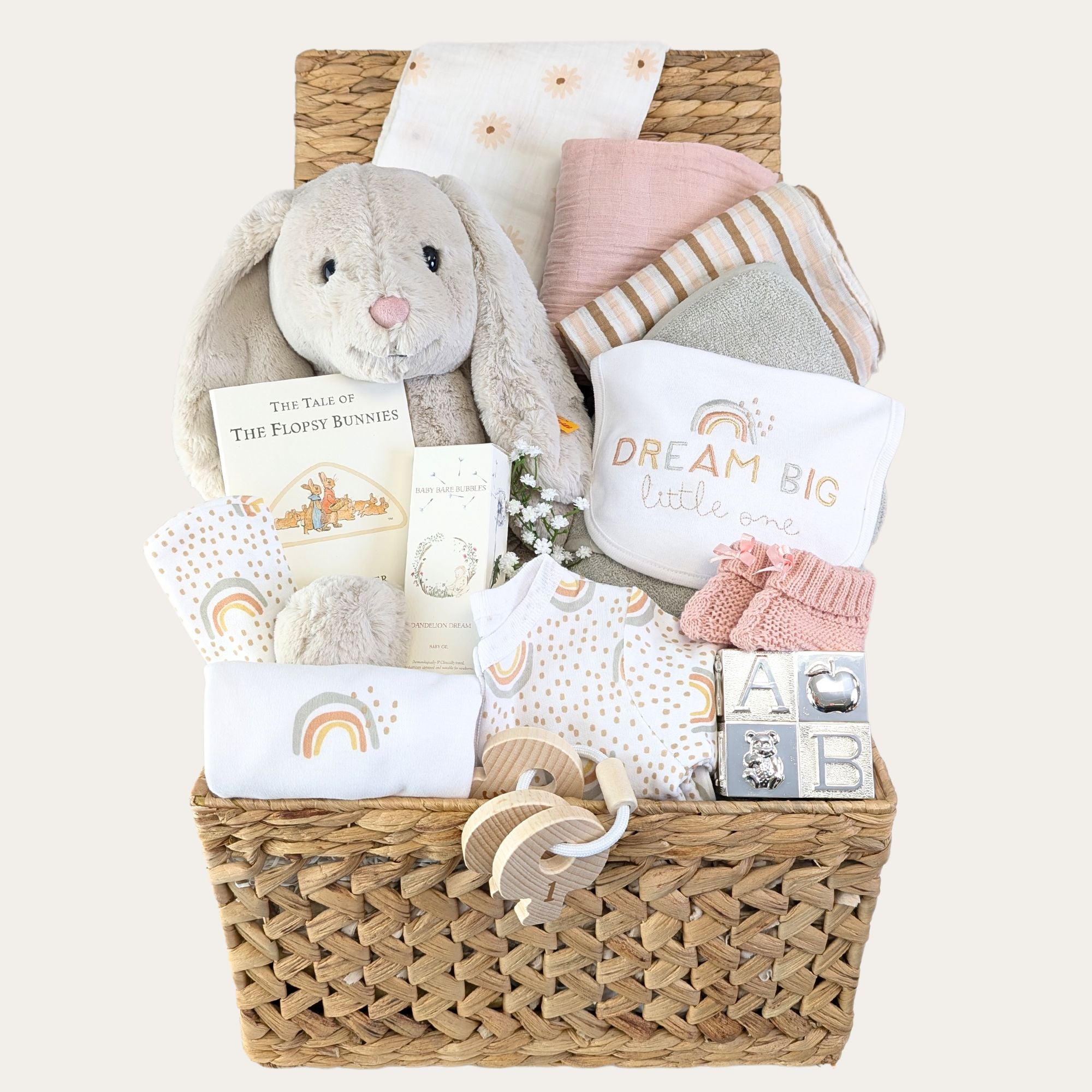 Baby girl hamper packed in a gifts basket. Includes large bunny, muslins, baby towel, book, clothing set and silver present.