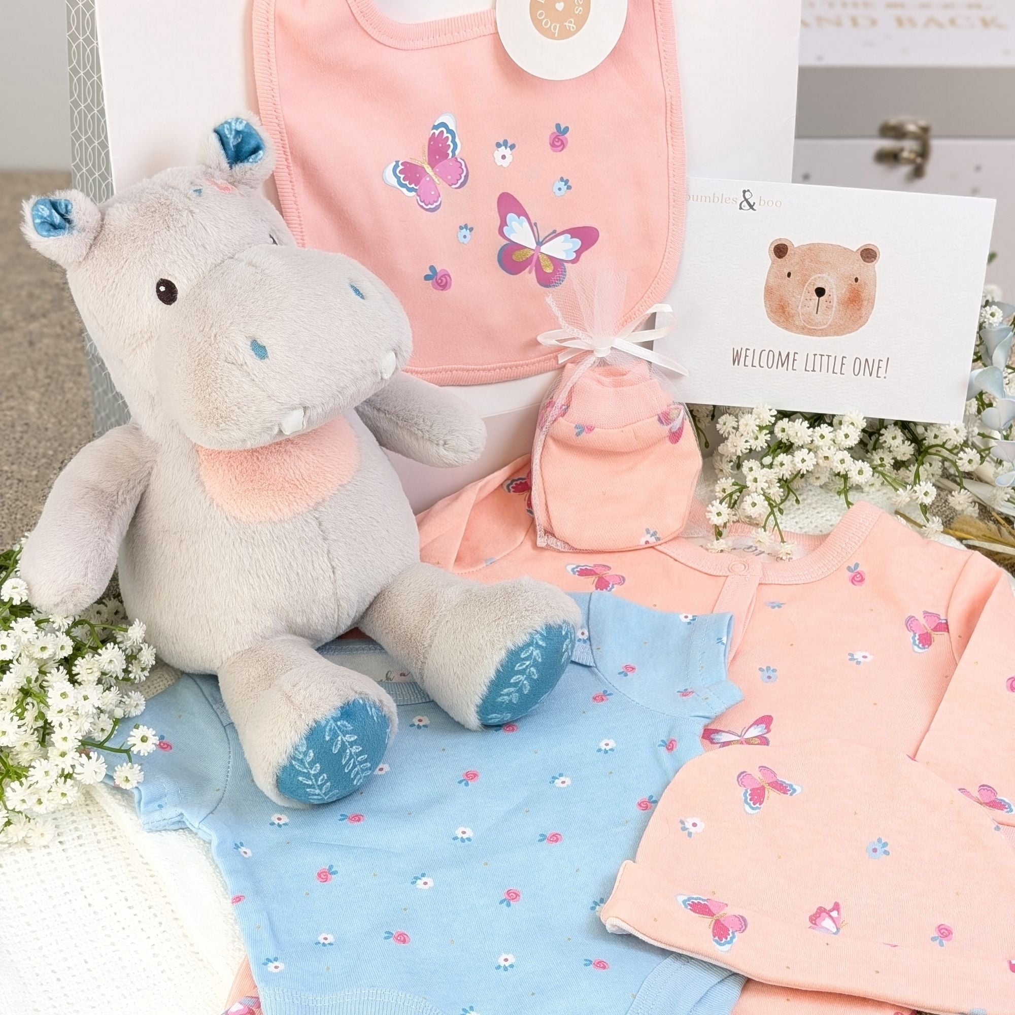 Baby girl gift bag with pink butterfly gifts clothes set and hungry hippo soft toy.