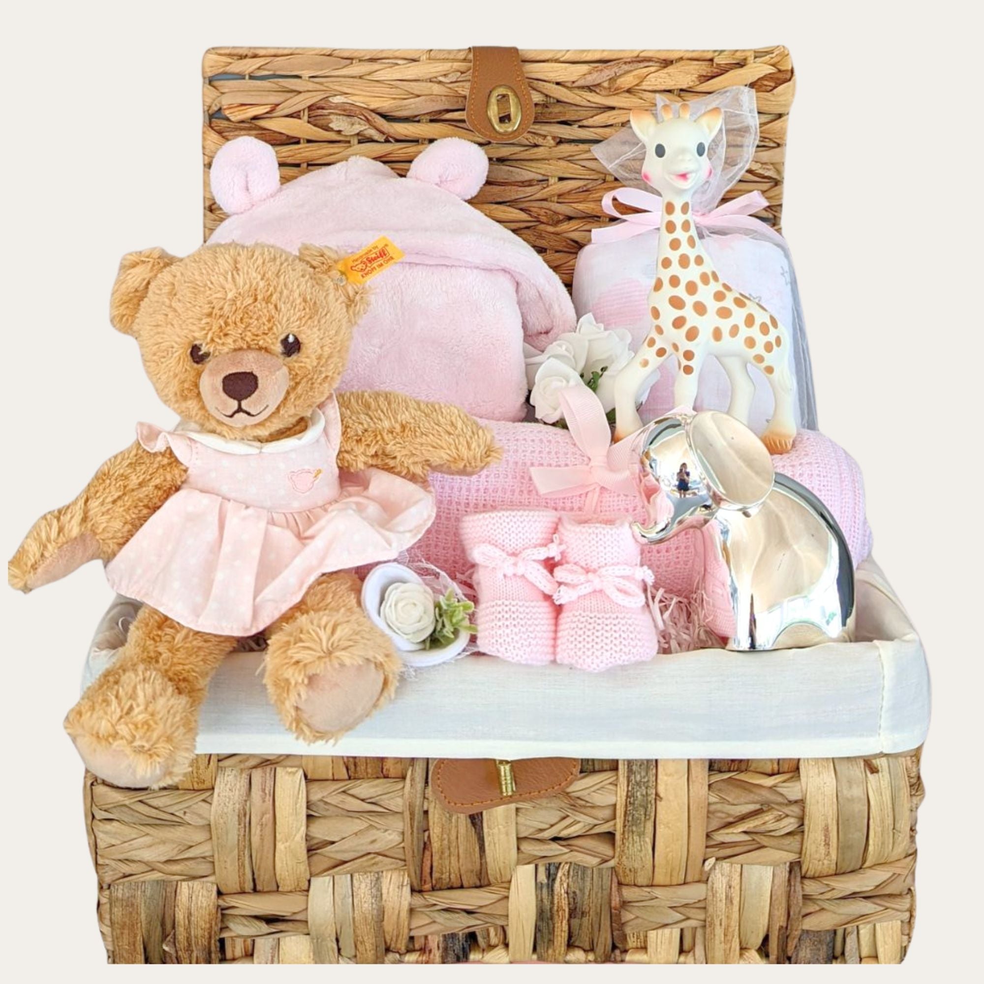 Baby girl hamper with luxury gifts of silver money bank, steiff teddy bear, blanket, bath robe and teething giraffe.