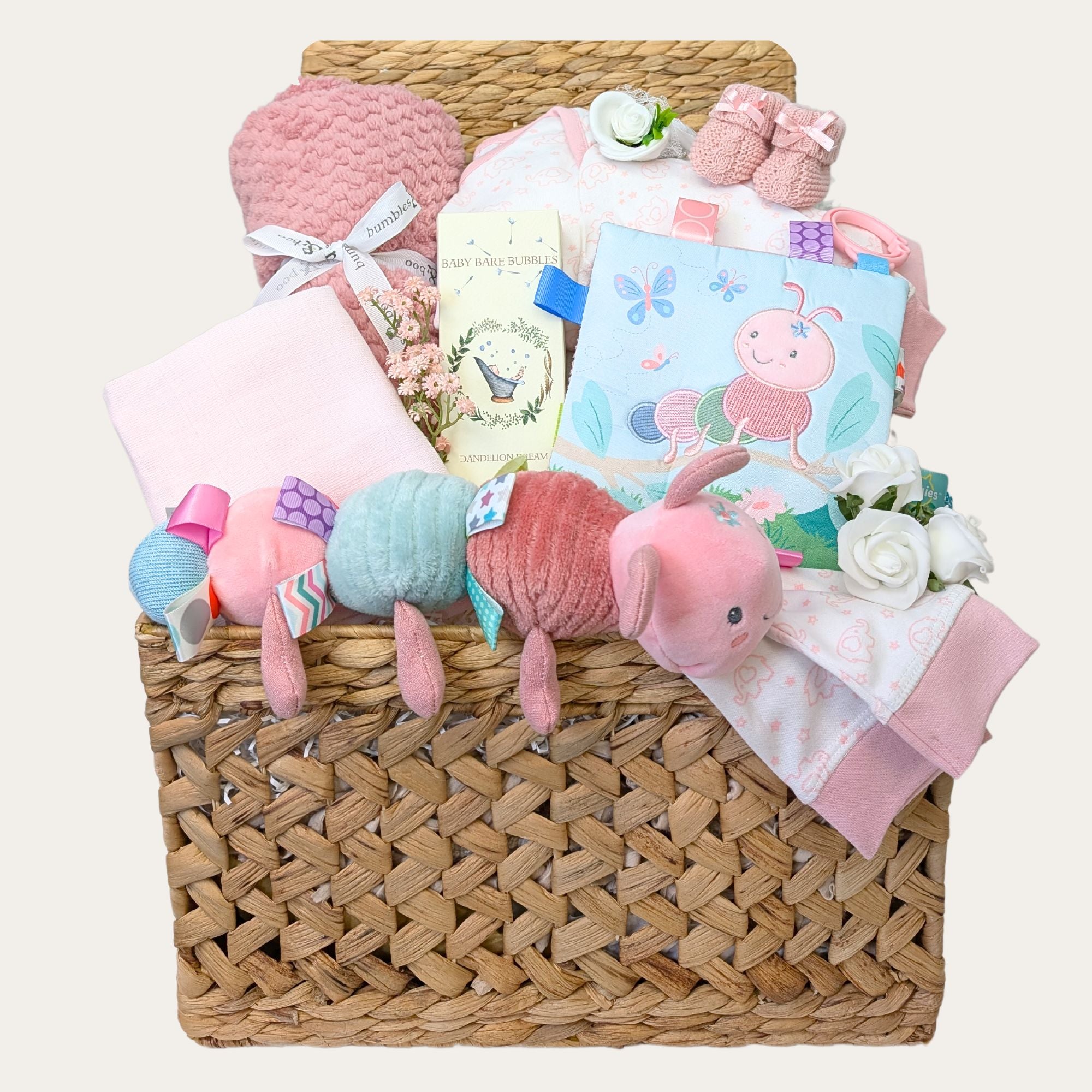 New baby girl gifts in a large hamper basket with pink striped baby clothes and blanket. Caterpillar themed baby toys and chocolate gifts for mummy.