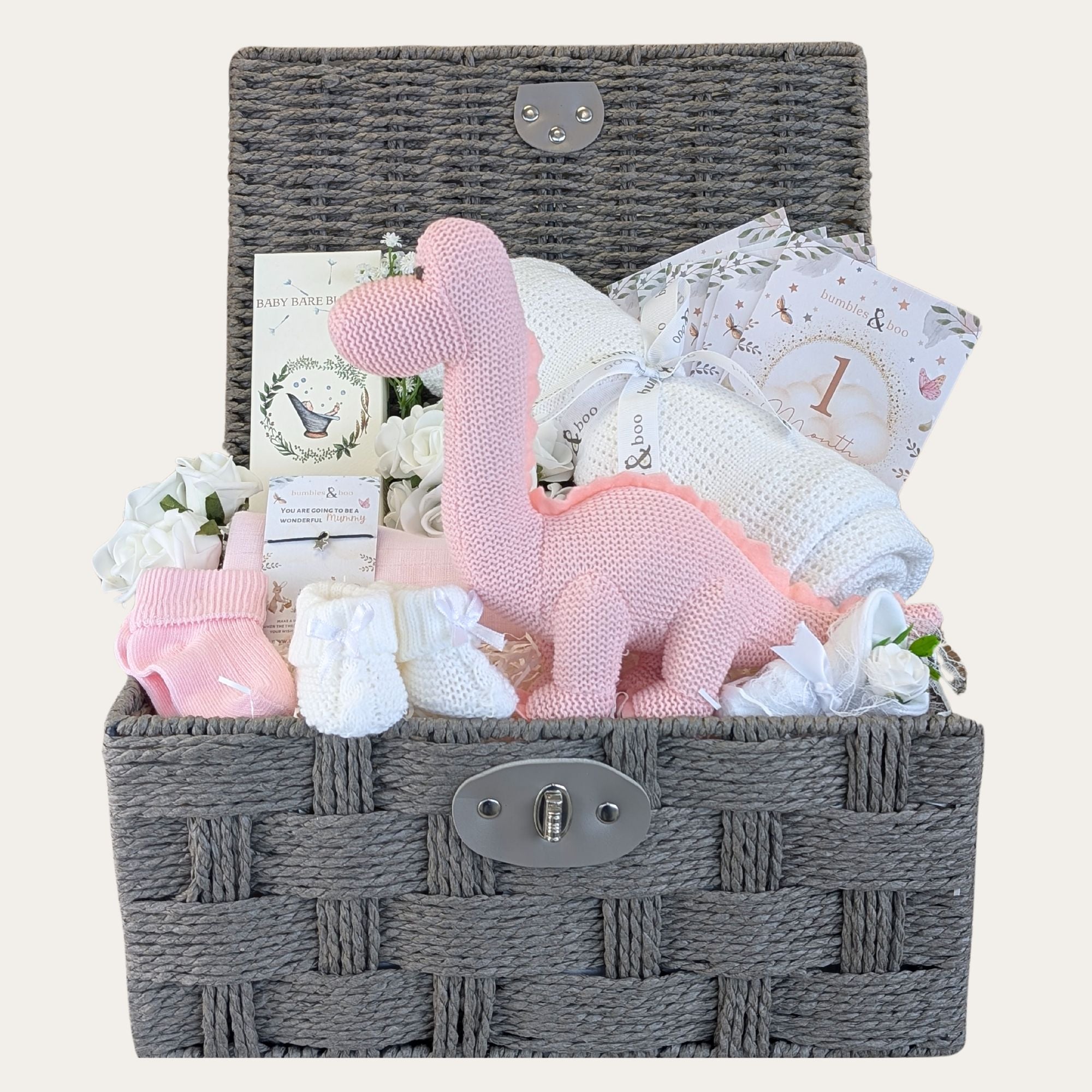 baby girl gifts basket with organic dinosaur, organic bubbles, baby blanket, milestone cards, baby socks, wish bracelet and mittens.