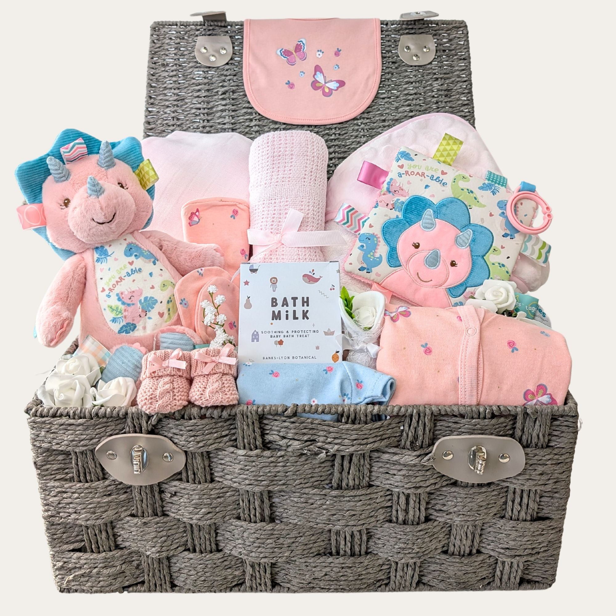 baby girl gifts hamper basket with pink baby clothes set and dotty dinosaur soft toy.