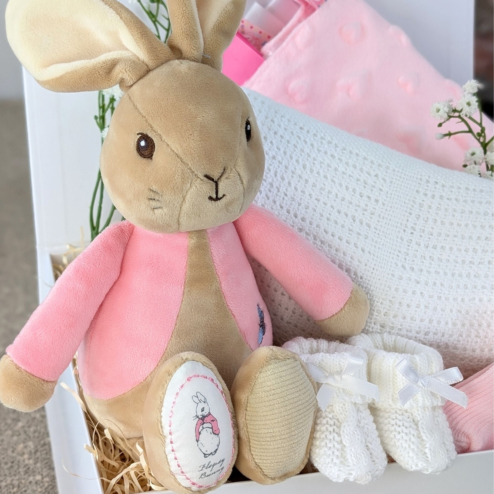 baby girl gifts box with flopsy bunny, cellular blanket, taggie comforter, baby socks and baby booties.