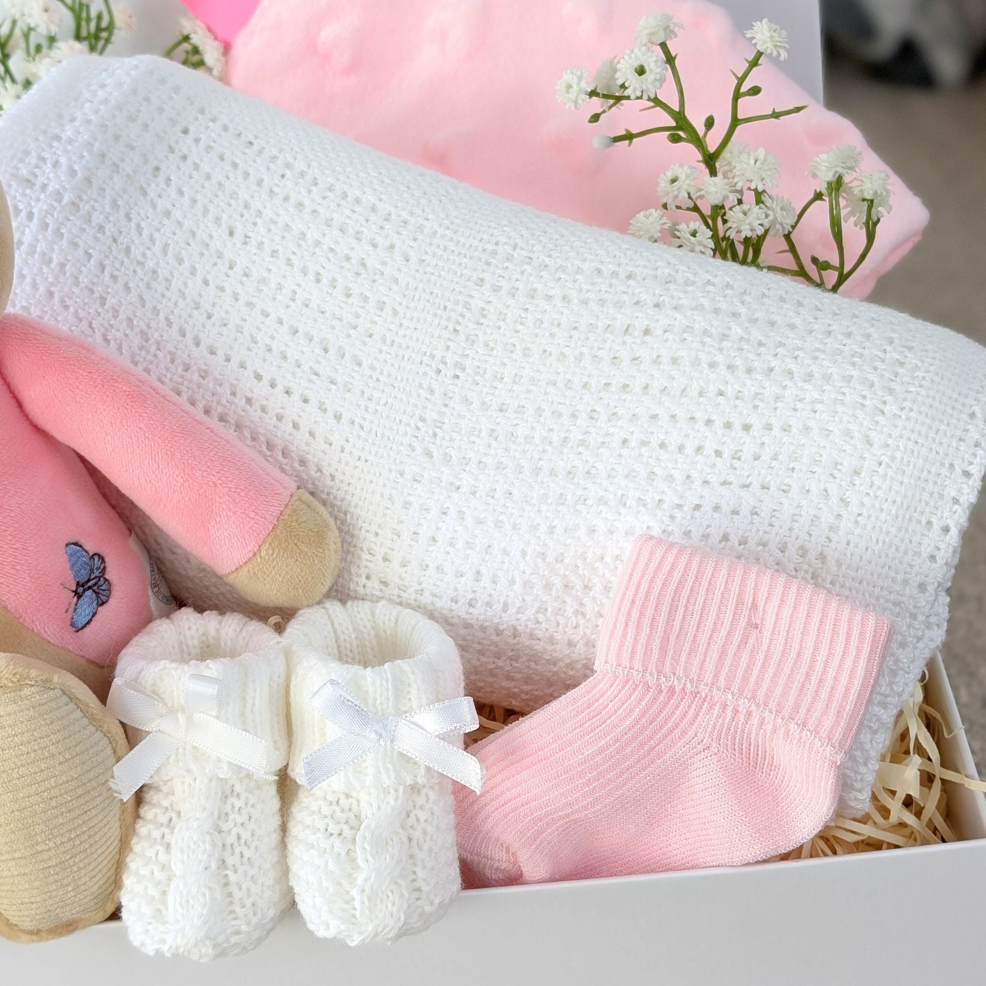 baby girl gifts box with flopsy bunny, cellular blanket, taggie comforter, baby socks and baby booties.