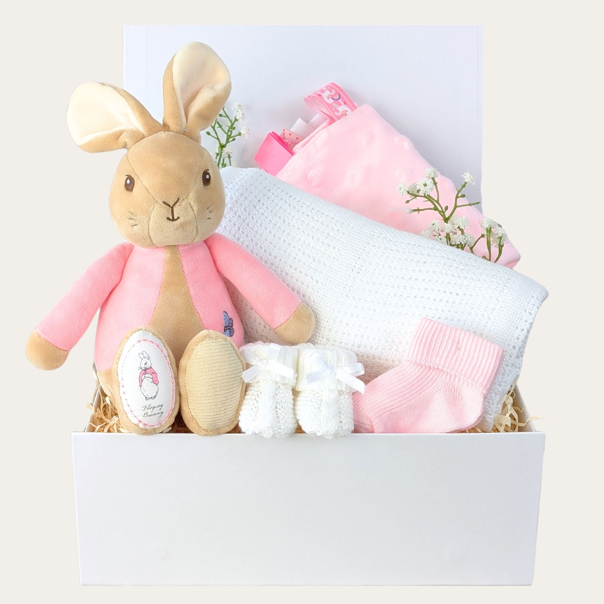 baby girl gifts hamper in a gifts box with flopsy bunny, cellular blanket, taggie comforter, baby socks and baby booties.