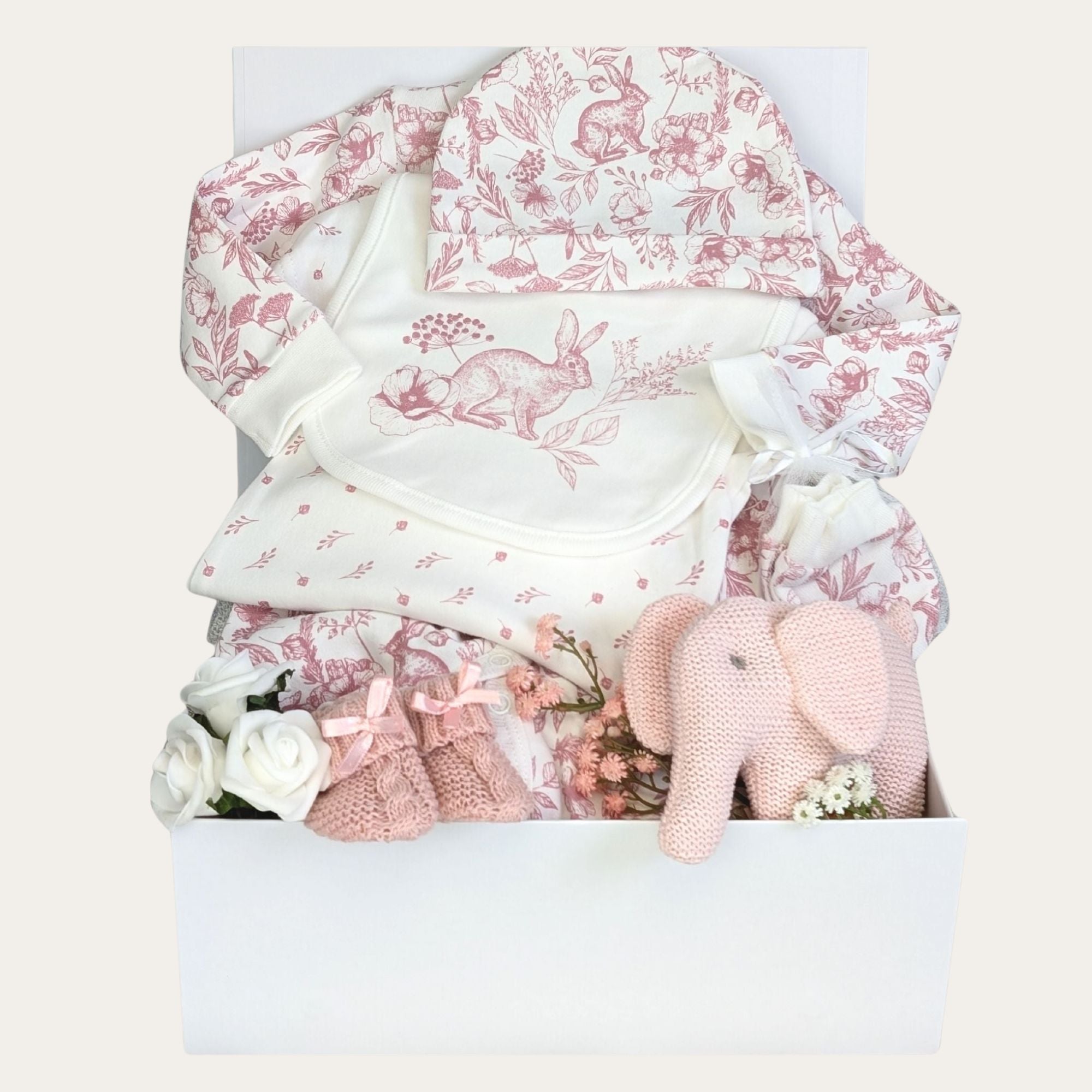 baby girl gifts hamper box with five piece clothing set, pink organic elephant rattle and baby booties.