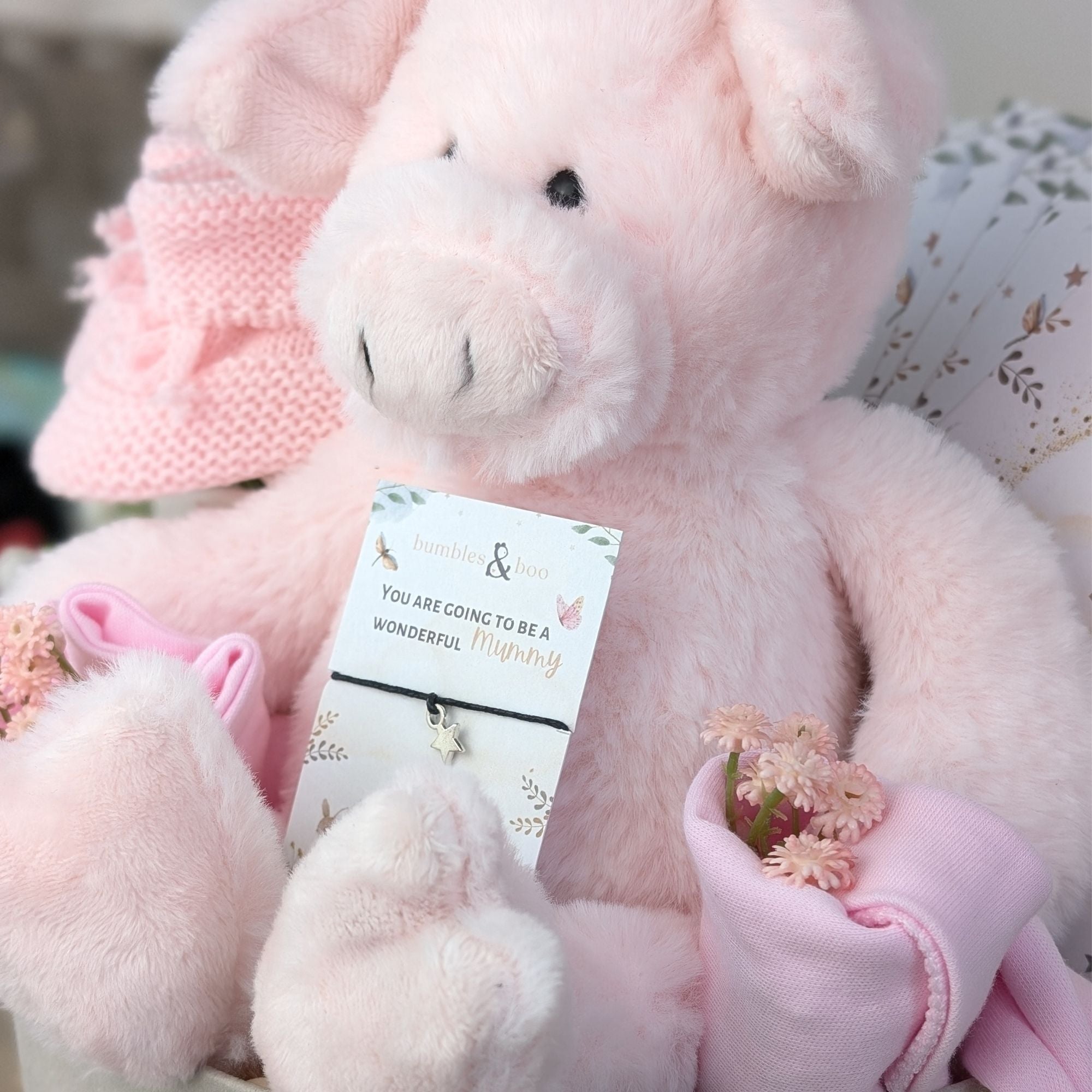 baby girl gifts box with pig soft toy in pink, baby booties, baby hat, baby bib, bracelet for mum and milestone cards.