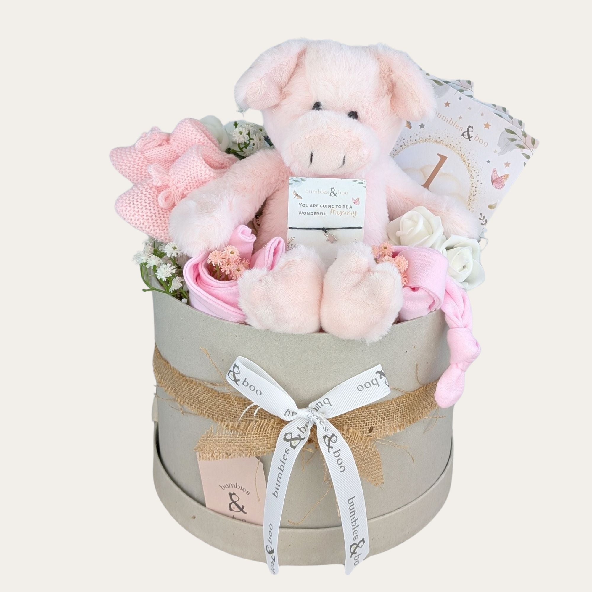 baby girl gifts box with pig soft toy in pink, baby booties, baby hat, baby bib, bracelet for mum and milestone cards.