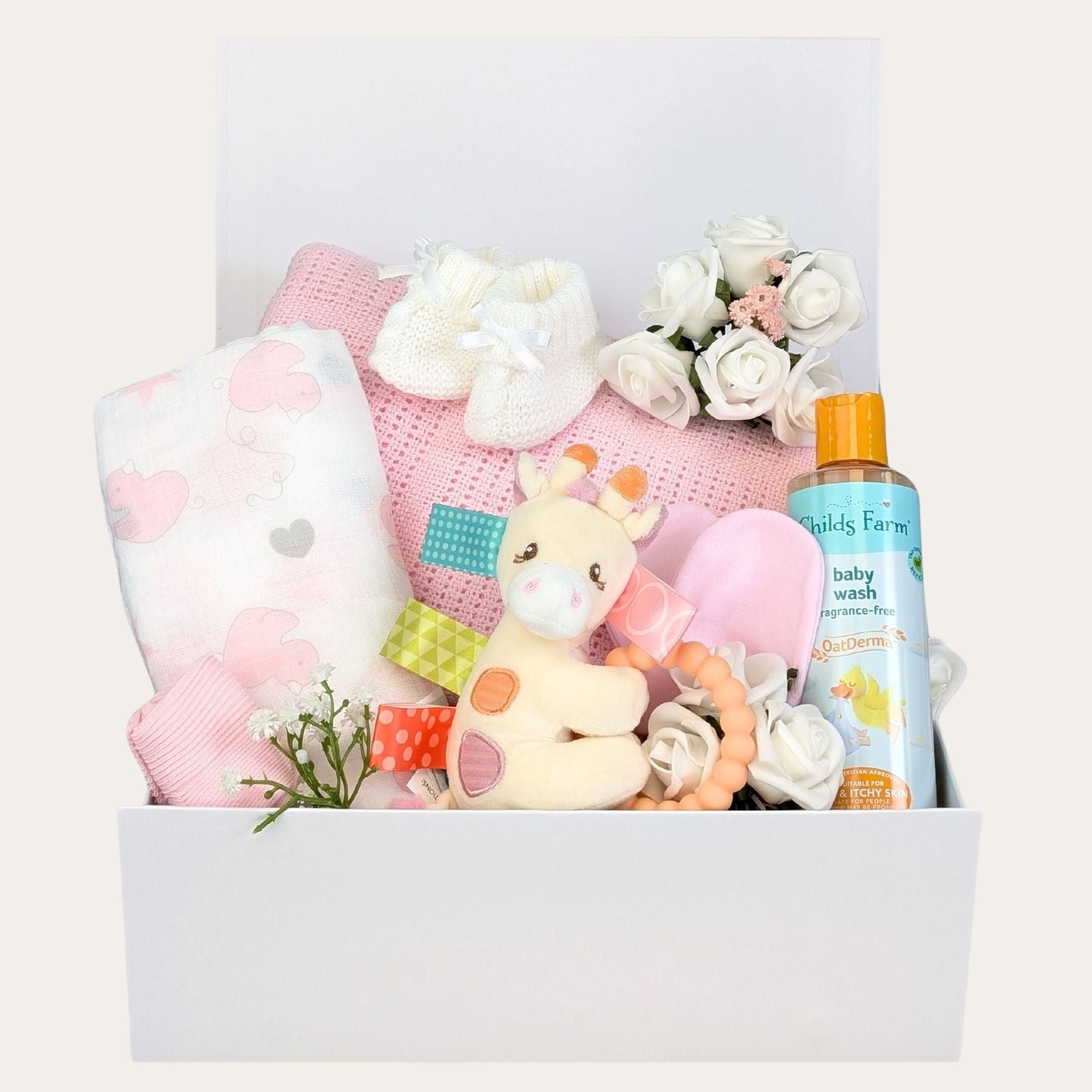 Newborn baby girl hamper. This white gifts box contains presents including a pink cellular blanket, muslin square and tilly giraffe teether.