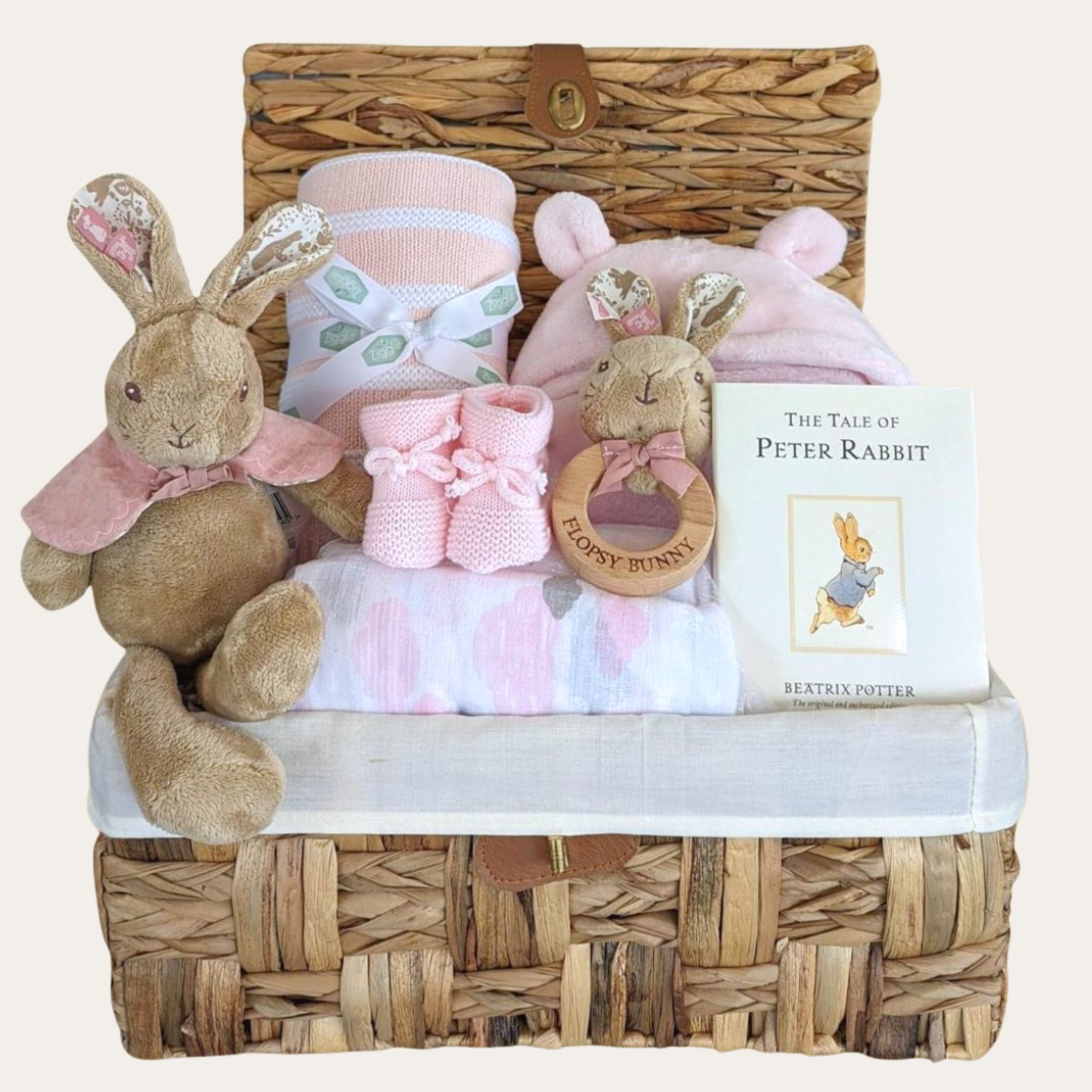 Baby girl gifts hamper with pink congratulations presents and Peter Rabbit theme. All packed in a hamper basket.