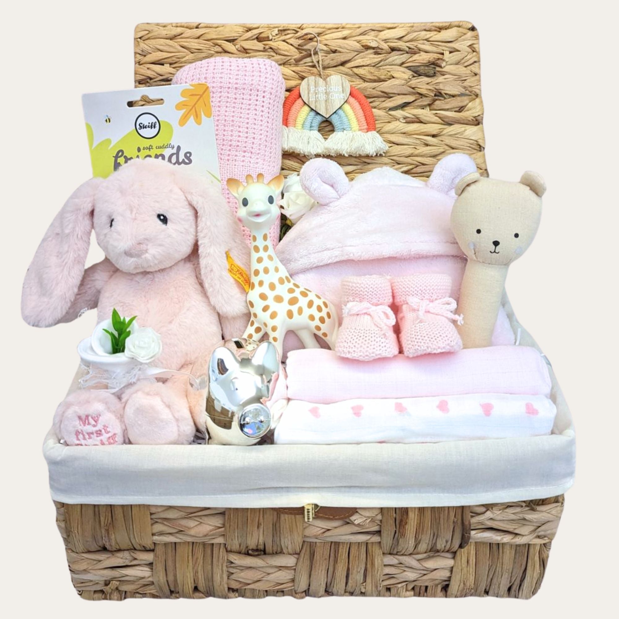 baby girl gifts hamper basket with gifts including pink bunny, cellular baby blanket, silver money box packed in a hamper basket.