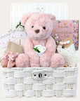 baby girl gifts hamper with large dusky pink teddy, chocolates, teething rings, nursery plaque, baby booties, hat and milestone cards.