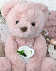 baby girl gifts hamper with large dusky pink teddy, chocolates, theething rings, nursery plaque, baby booties, hat and milestone cards.