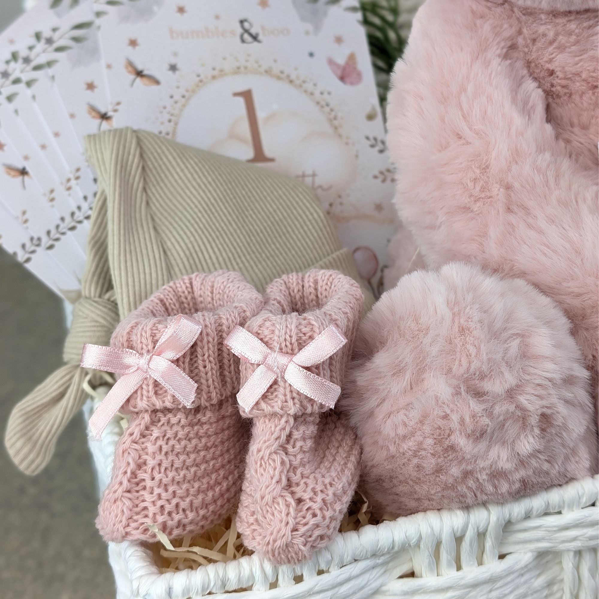 baby girl gifts hamper with large dusky pink teddy, chocolates, theething rings, nursery plaque, baby booties, hat and milestone cards.