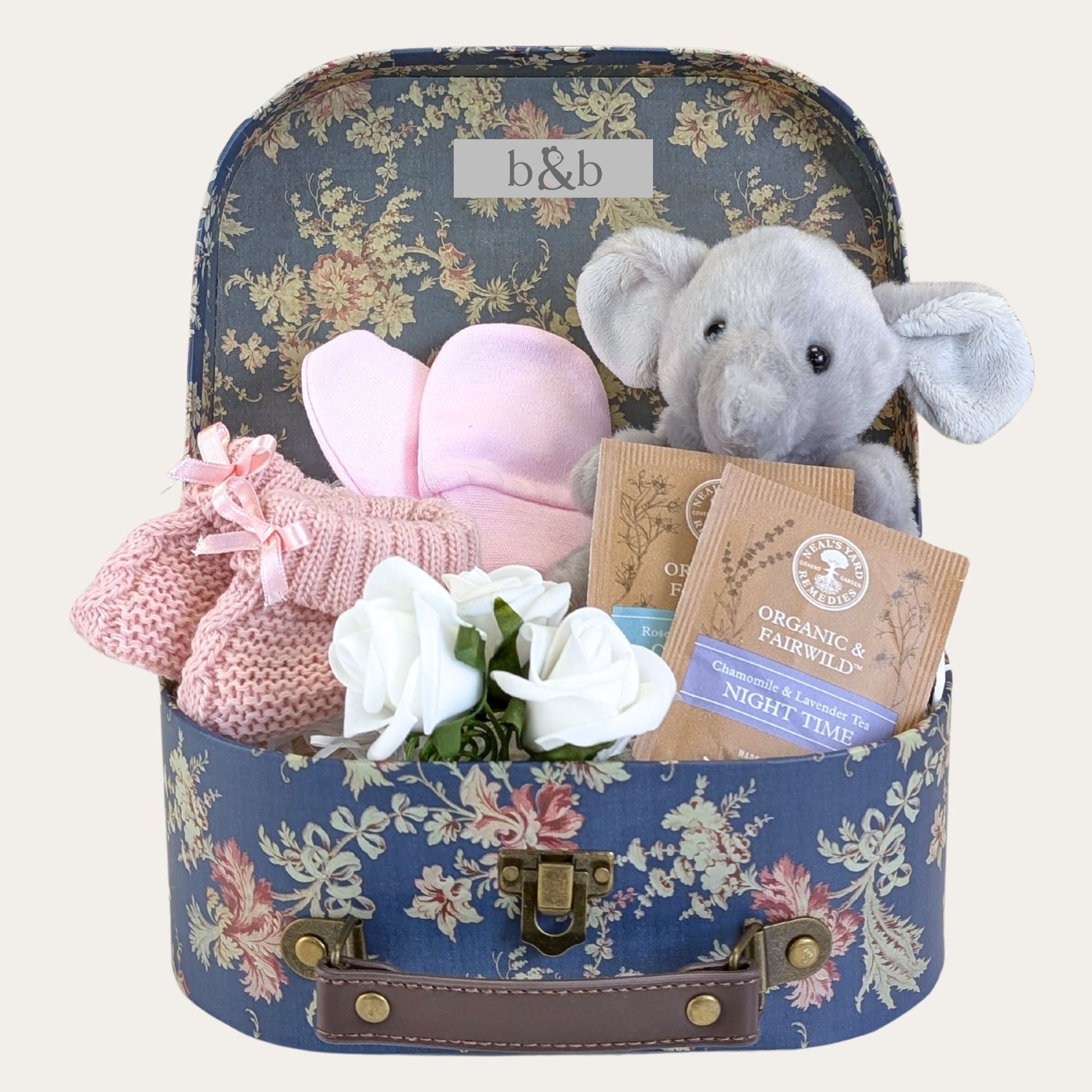 blue floral baby girl gifts hamper with elephant soft toy & tea in a suitcase.