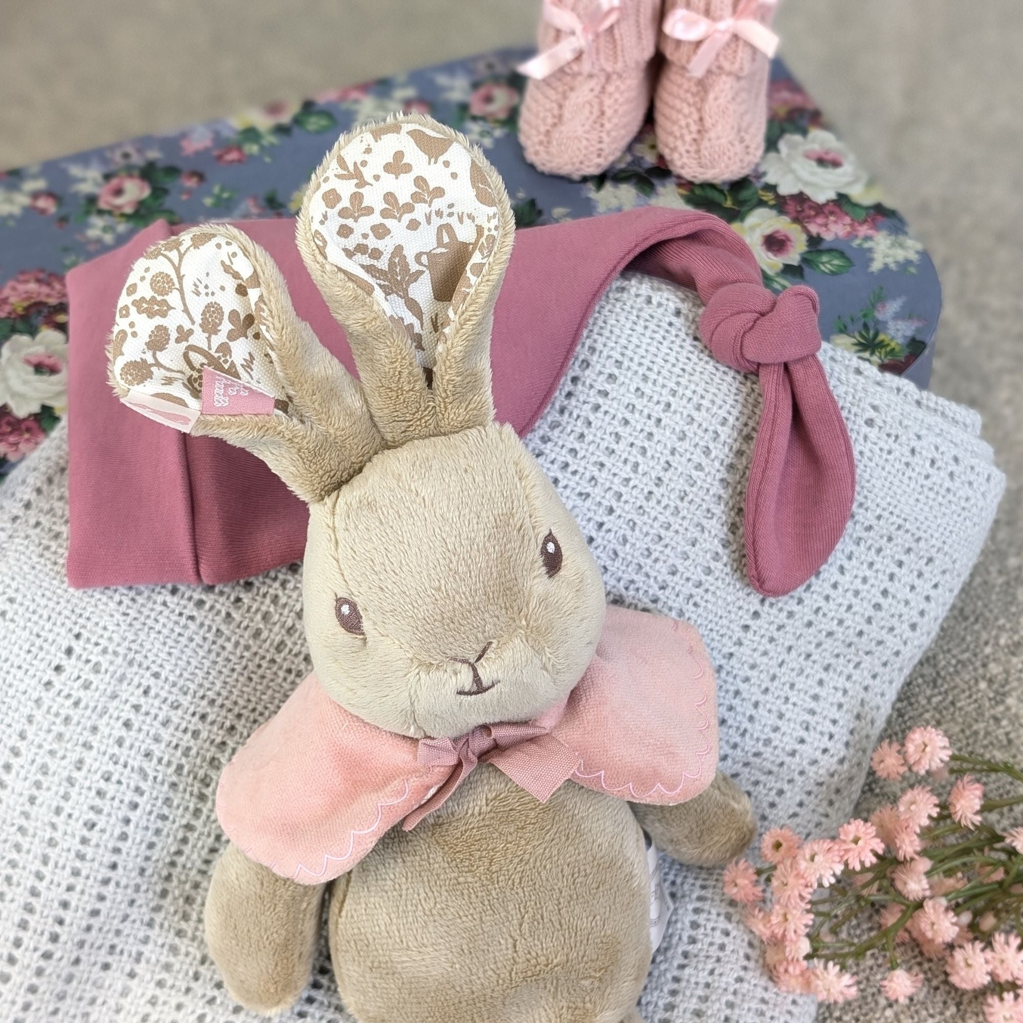 baby girl gifts trunk with flopsy bunny soft toy, baby hat, baby blanket and baby booties.