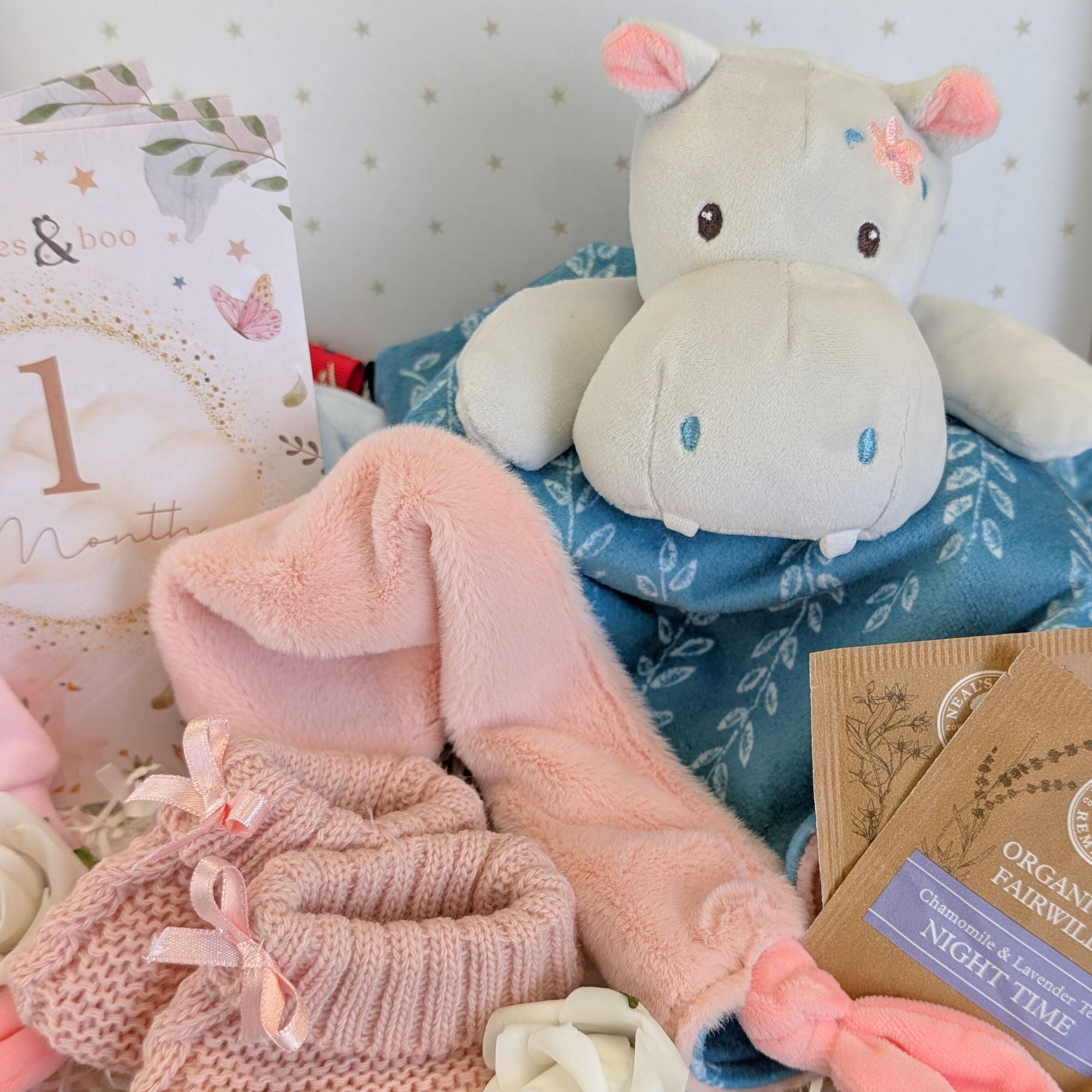 close up of hippo soft toy and baby milestone cards